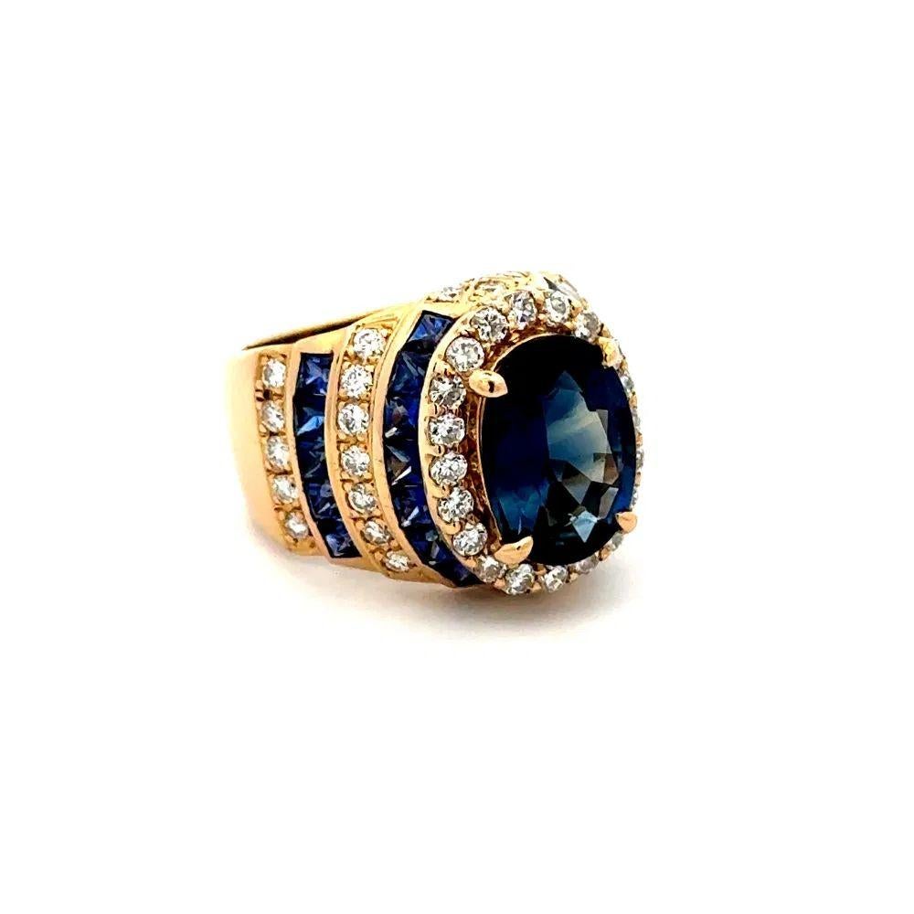 Simply Beautiful! Finely detailed Sapphire GIA and Diamond Gold Ring. Centering a securely nestled Hand set 4.12 Carat Oval GIA Sapphire. Surrounded by Diamonds, weighing 1.08tcw and Sapphires, approx. 2.10tcw. Hand crafted 18K Yellow Gold mounting.