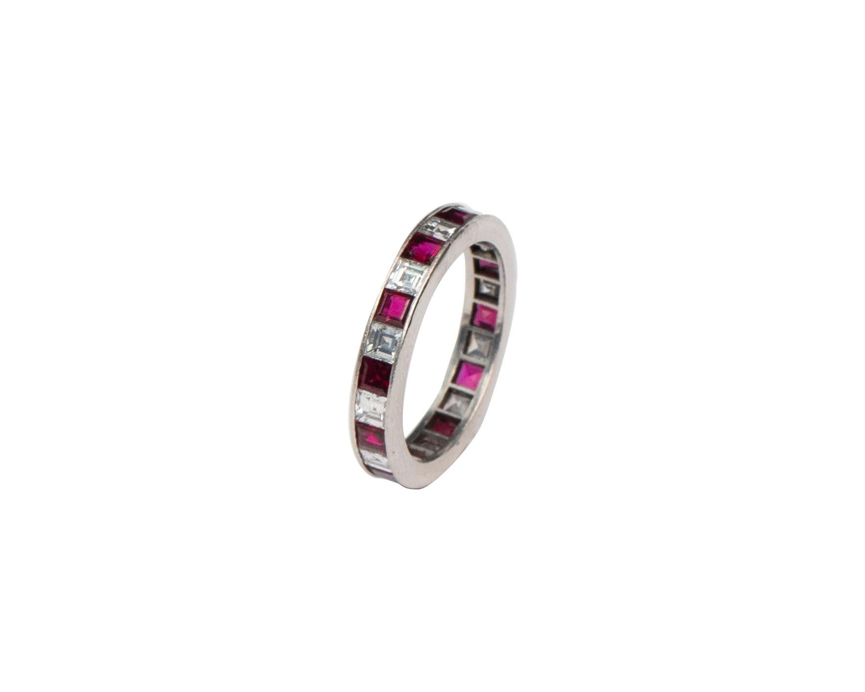 This piece is a genuine vintage style eternity band with over 4 carats of beautiful, perfectly matched, diamonds and rubies channel set in platinum! There is a pierced open back pattern throughout the ring to allow light and brilliance to be at a