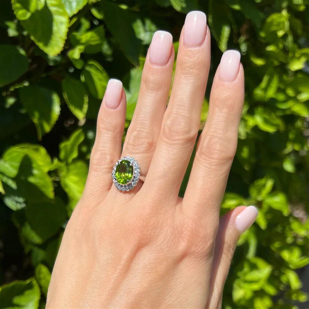 Modern Vintage 4.19 Carat Oval Peridot and Diamond Platinum Halo Ring For Sale