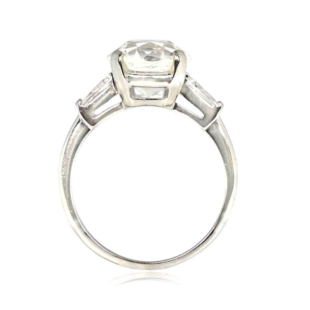 The essence of vintage elegance with this diamond solitaire engagement ring, featuring a 4.25 carat old European cut diamond at its center, flanked by tapered baguette cut diamonds on either side. The center diamond, with a K color grade and VS2