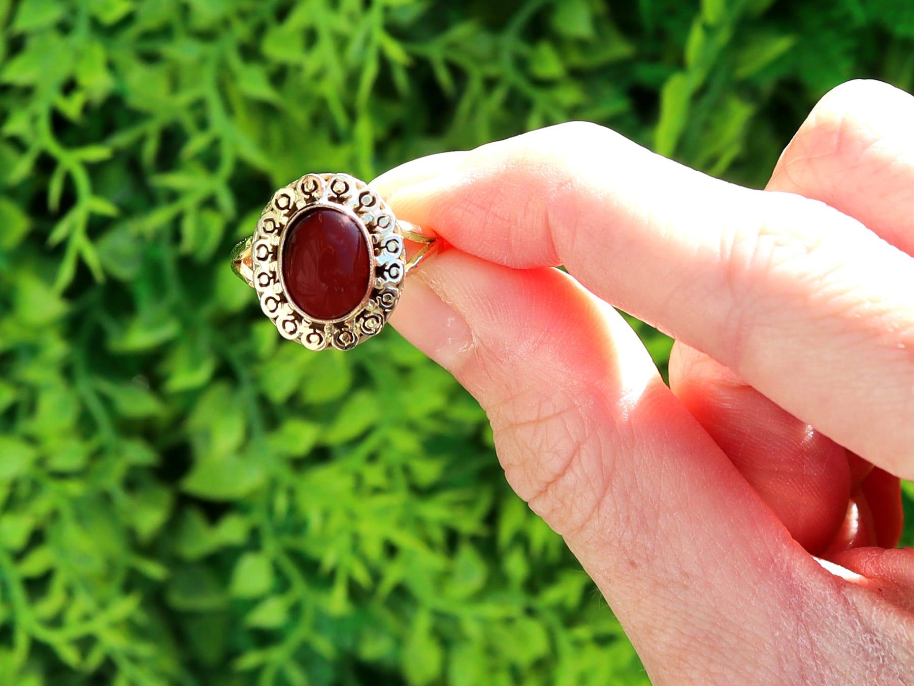 A fine and impressive vintage 4.43 carat garnet and 18 karat yellow gold dress ring; part of our diverse collection of vintage rings.

This fine and impressive vintage garnet ring has been crafted in 18k yellow gold.

The oval shaped ring setting