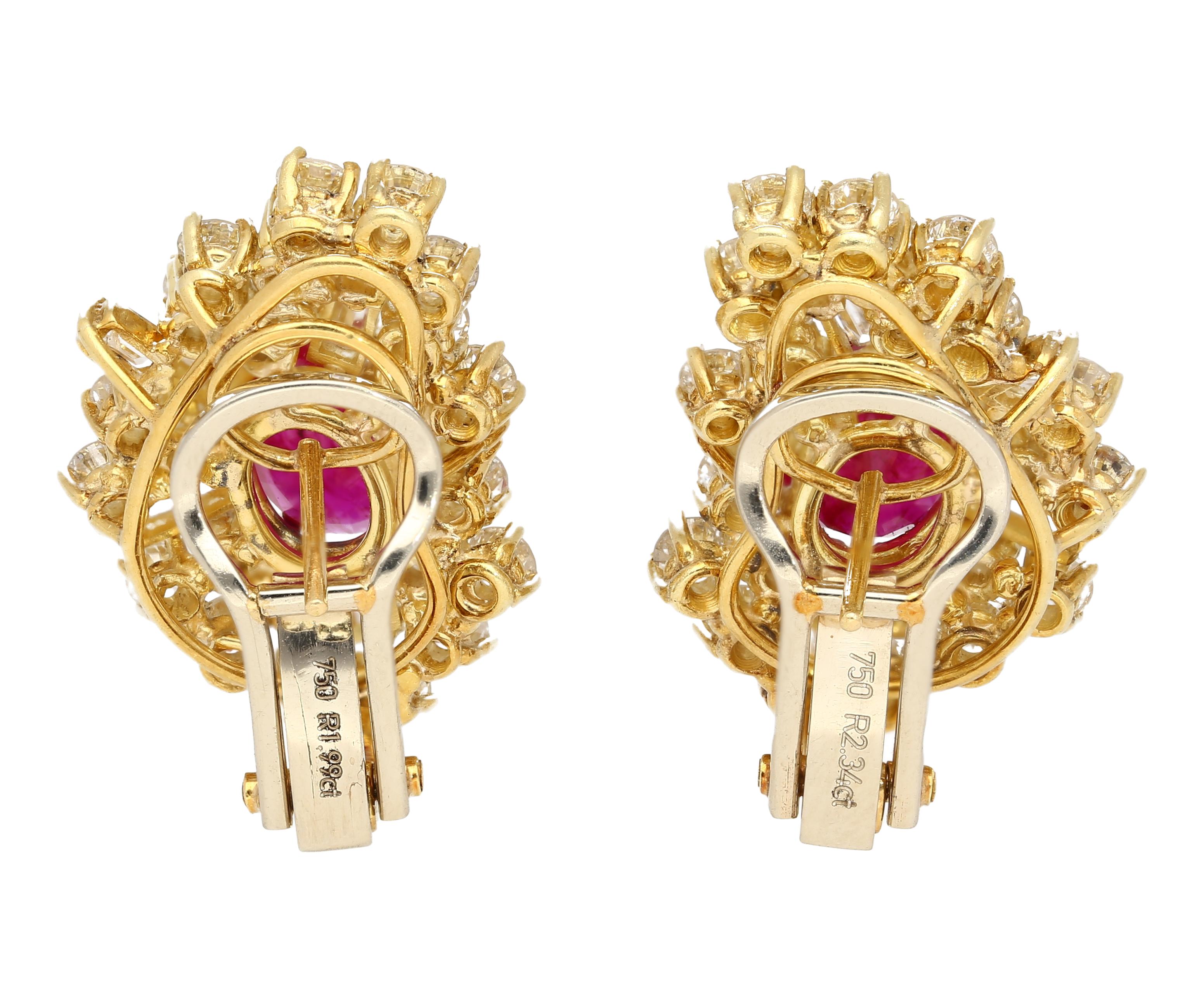 Vintage Ruby and Diamond Earrings in 18K Yellow Gold.

These earrings each feature an oval-cut red ruby center stone, totaling 4.50 carats in weight. The ruby is paired with a decorative array multi-cut diamonds, including baguette and round, for a