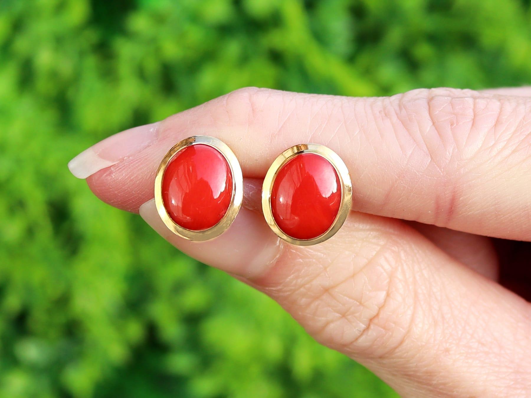 An impressive pair of vintage Italian 4.50 carat red coral and 18k yellow gold stud earrings; part of our diverse vintage estate jewelry collections.

These fine and impressive Italian coral earrings have been crafted in 18k yellow gold.

Each oval
