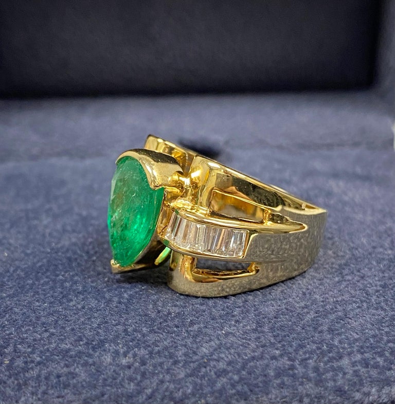 Pear shape natural Emerald men's ring in 14k gold setting. A unique and elaborate ring design with a 4.50 pear shape center stone and 12 high-quality natural diamonds. 

This ring is not for those in search of a conventional men's ring. This ring is