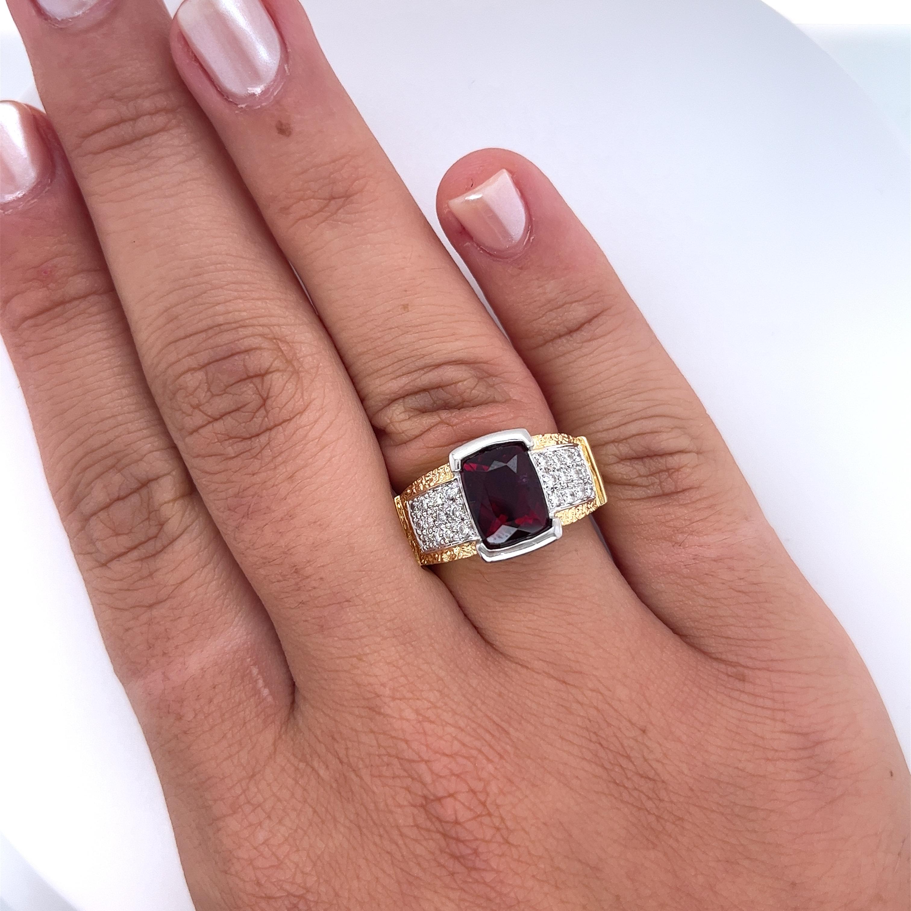 Vintage radiant cut Rubellite Tourmaline and diamond ring in 18k gold and platinum setting. Ideal as a man's pinky ring or a woman's statement ring. This piece features a textured ring shank and a richly saturated center stone. Half bezel set center