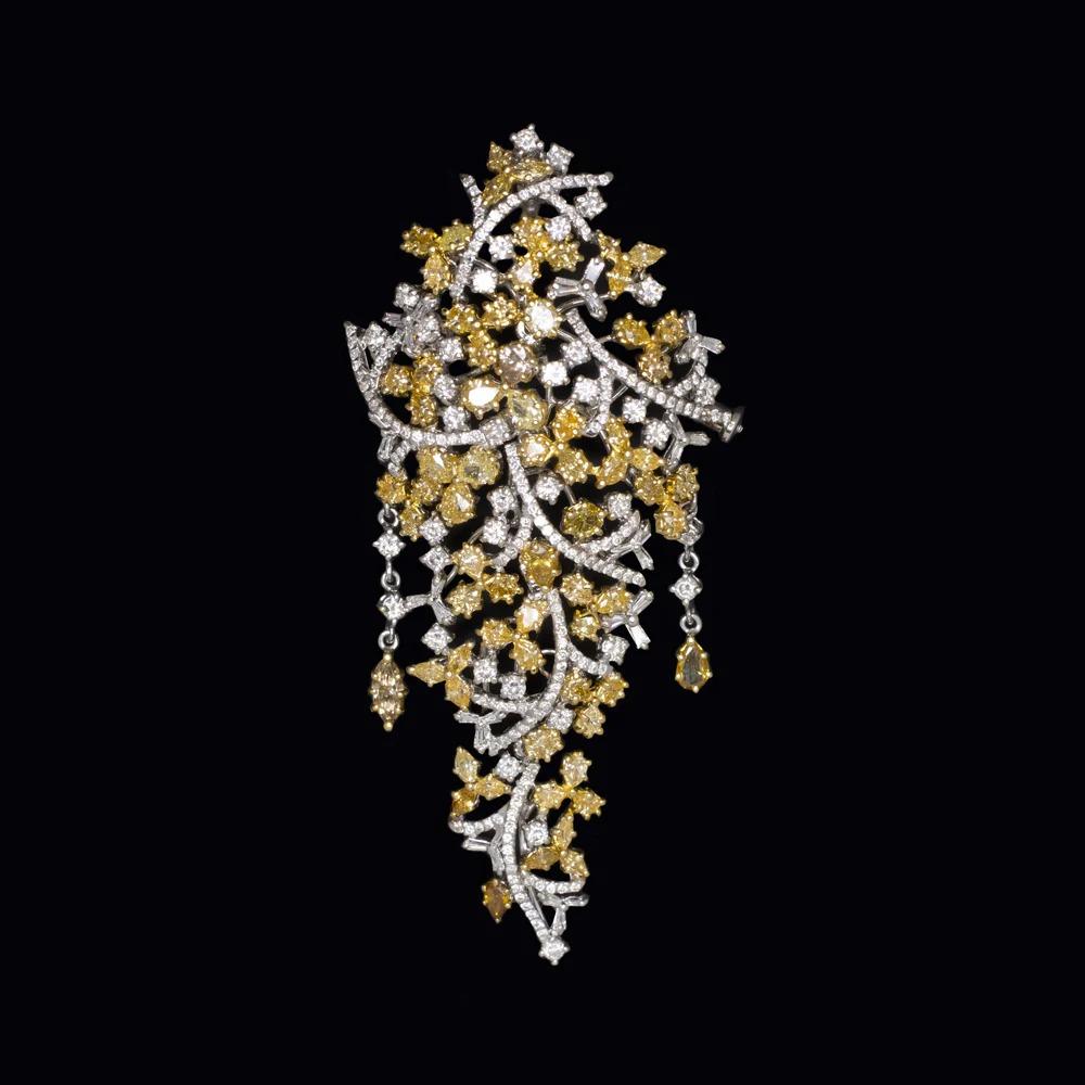 Striking Fancy Yellow & White Diamond Pendant/Brooch  4.51ct Total  18K White & Yellow Gold

Radiant and whimsical, this one-of-a-kind pendant dazzles with a graceful, cascading cluster of fancy yellow and bright white diamonds—bringing joyful