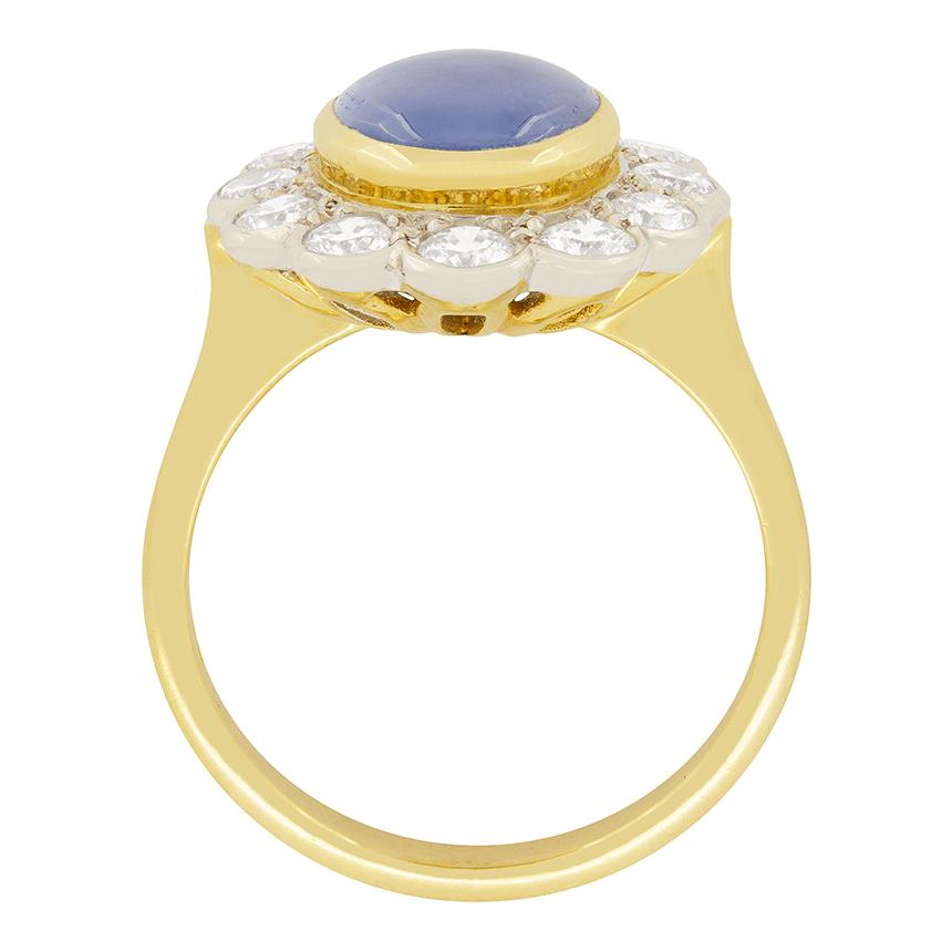 A bright and sparkling halo of round brilliant cut diamonds surround a captivating star sapphire. The twelve diamonds total to 1.20 carats and are F in colour and Vs in clarity truly highlighting the sapphire which weighs 4.50 carat. It has been rub