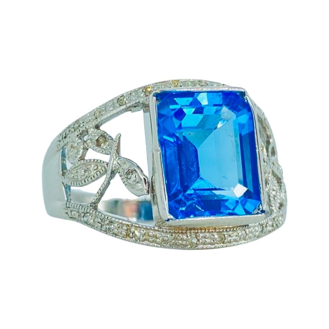 Vintage 4.58 Total Carat Weight Aquamarine and Diamonds Floral Cocktail Ring. The Aquamarine measures 12mm X 9.60mm X 5.50mm for a carat weight of 4.34 and the diamonds featured are round with a total of 0.24 carat for a combined 4.58 total carat