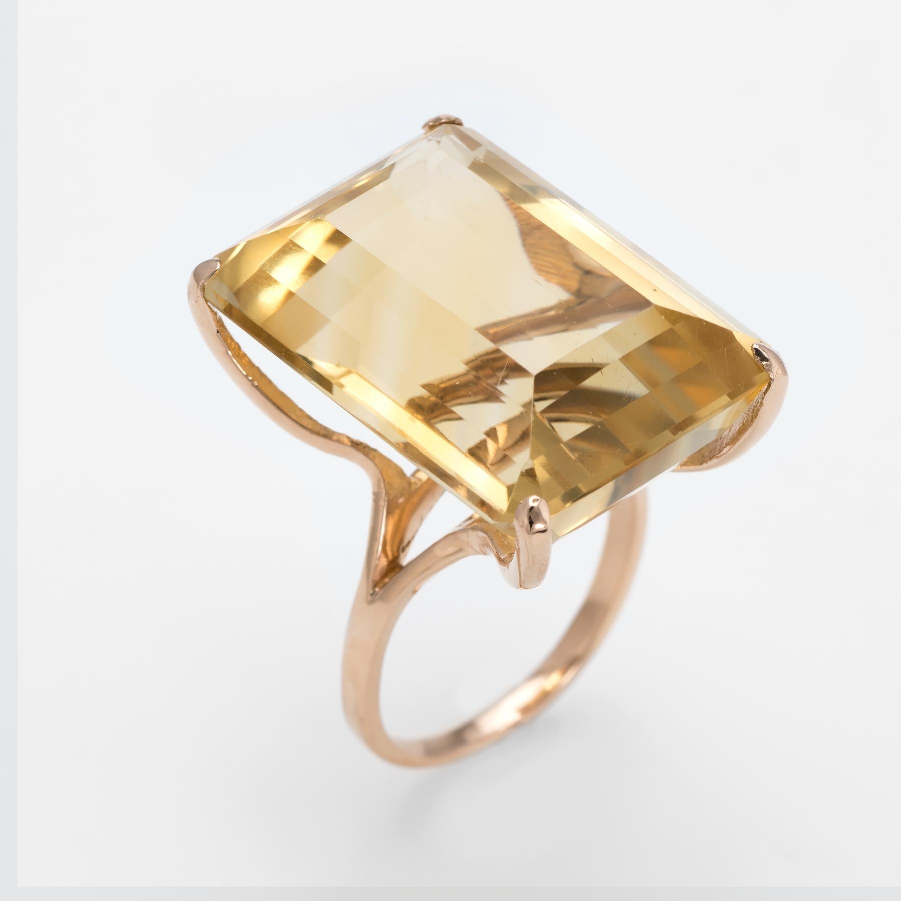 Finely detailed vintage citrine cocktail ring (circa 1960s to 1970s), crafted in 14 karat yellow gold. 

Emerald cut citrine measuring 26mm x 19mm (estimated at 45 carats) is set into the mount. The citrine is in excellent condition and free of