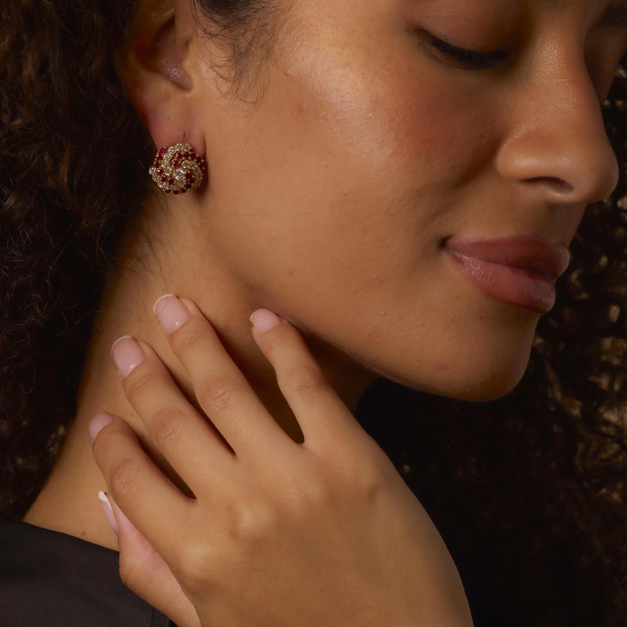 These vintage 18k yellow gold earrings showcase radiant F color diamonds and vivid rubies in a bold, fiery design with exceptional craftsmanship and presence.