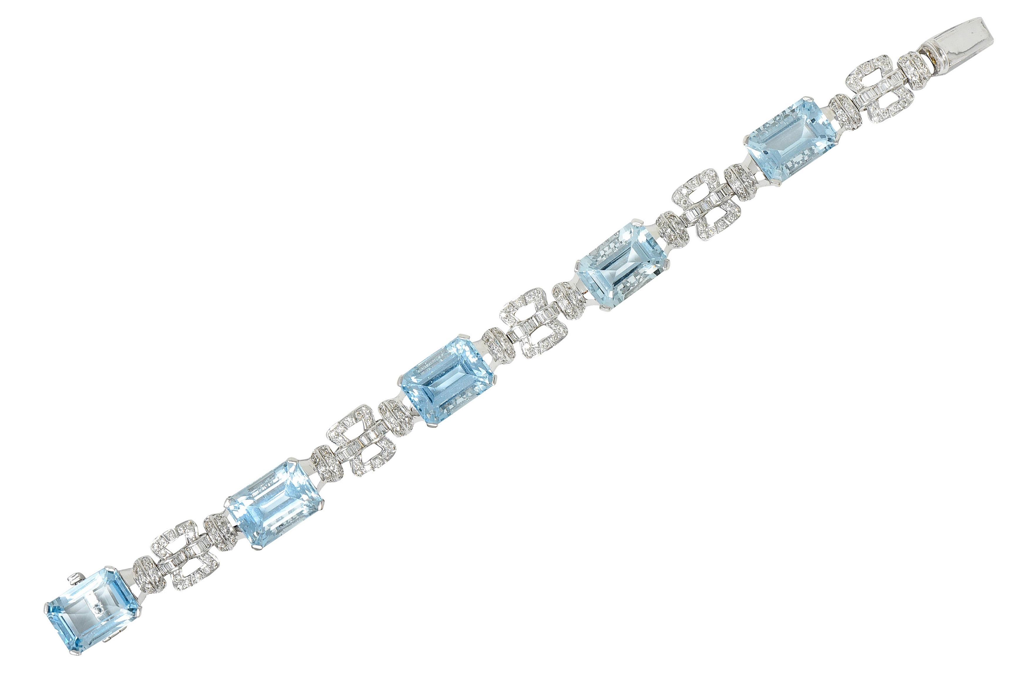 Link bracelet features emerald cut aquamarines weighing approximately 43.00 carats

Set by wide prongs in decoratively scrolled baskets - exhibiting transparent medium light greenish blue color

With stylized buckle links flanked by rondelle spacer