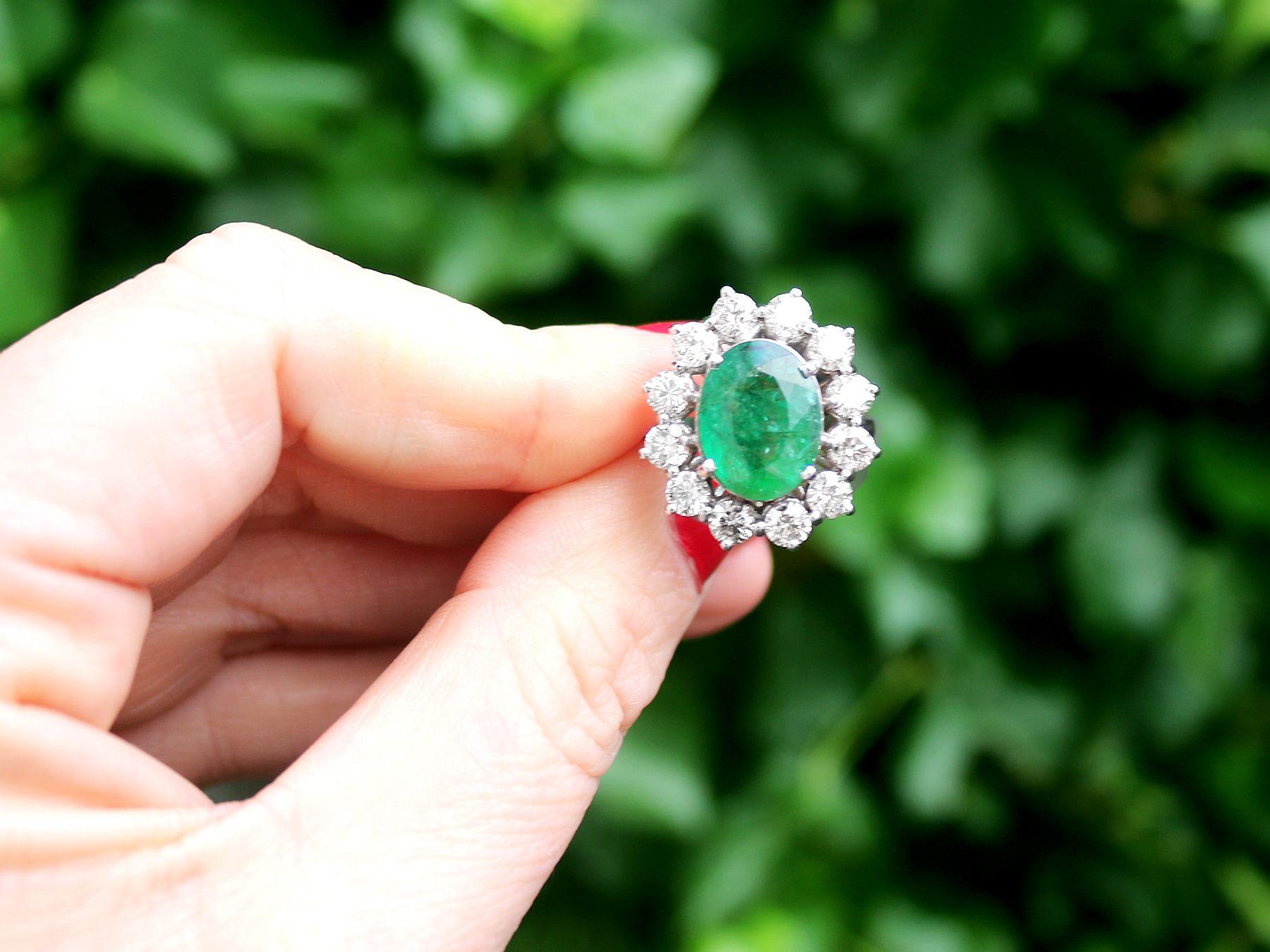 A stunning, fine and impressive vintage 4.82 carat natural emerald and 3.12 carat diamond, 18 karat white gold cluster ring; an addition to our vintage jewelry and estate jewelry collections

This impressive vintage emerald dress ring has been