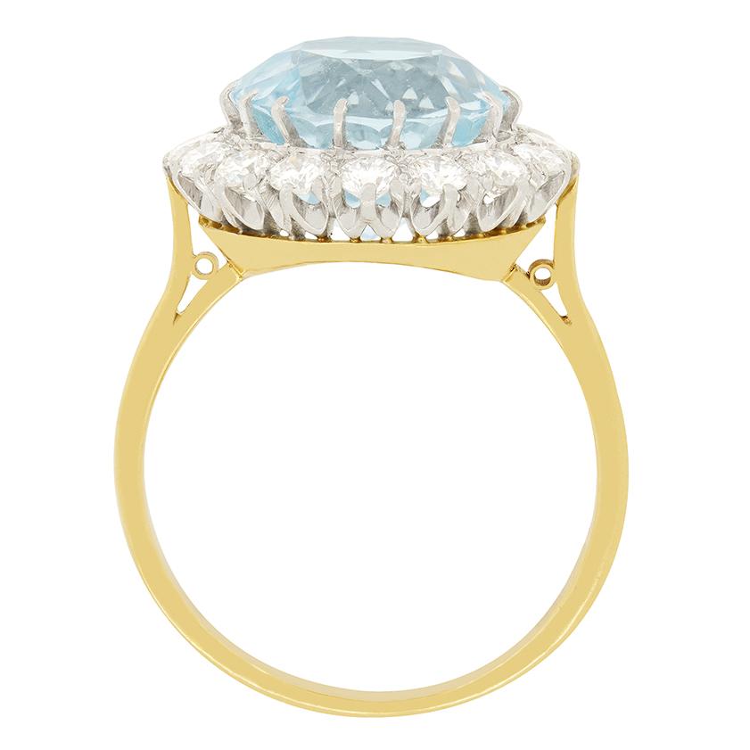 A substantial aquamarine is claw set in a platinum collet, surrounded by a halo of round brilliant cut diamonds, totalling to 1.12 carat. The aqua weighs 4.85 carat and is a gorgeous sky blue in colour. The surrounding bright diamonds are G in