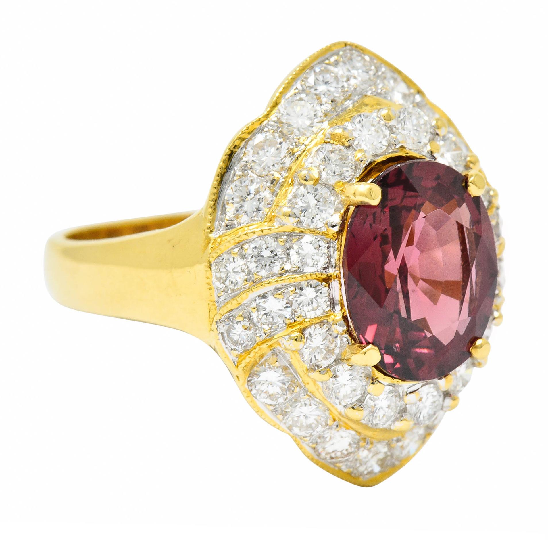 Designed as a subtle navette form with two tiers of diamonds and gold milgrain

Centering an oval cut natural spinel weighing approximately 3.06 carats

Transparent and brownish-red in color with no indications of heat

Surrounding round brilliant