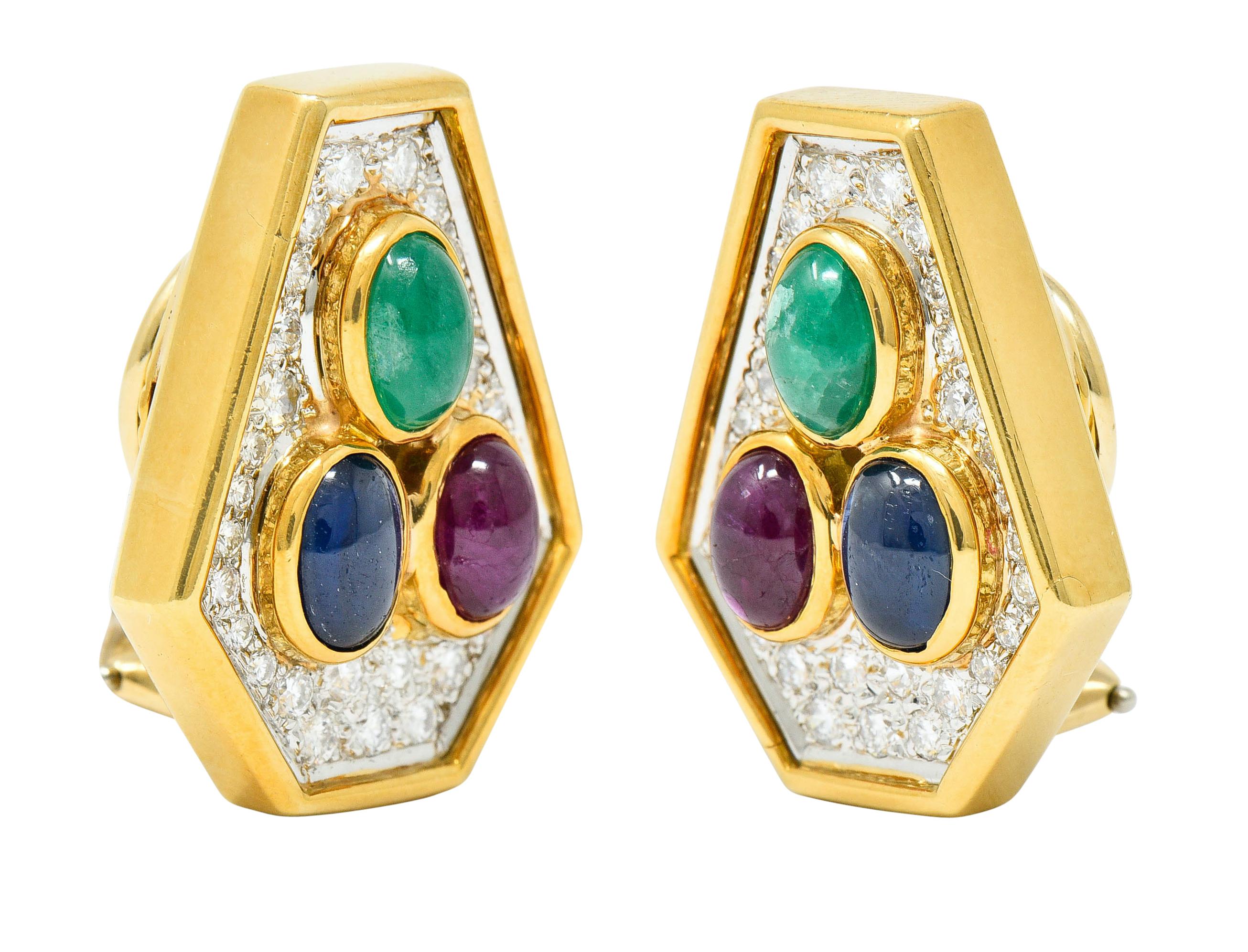 Earrings are shaped as elongated hexagons centering a triad of bezel set cabochons

Rubies, sapphires, and emeralds are brightly colored and weigh in total approximately 3.55 carats

Surrounded by a recessed halo of round brilliant cut diamonds,