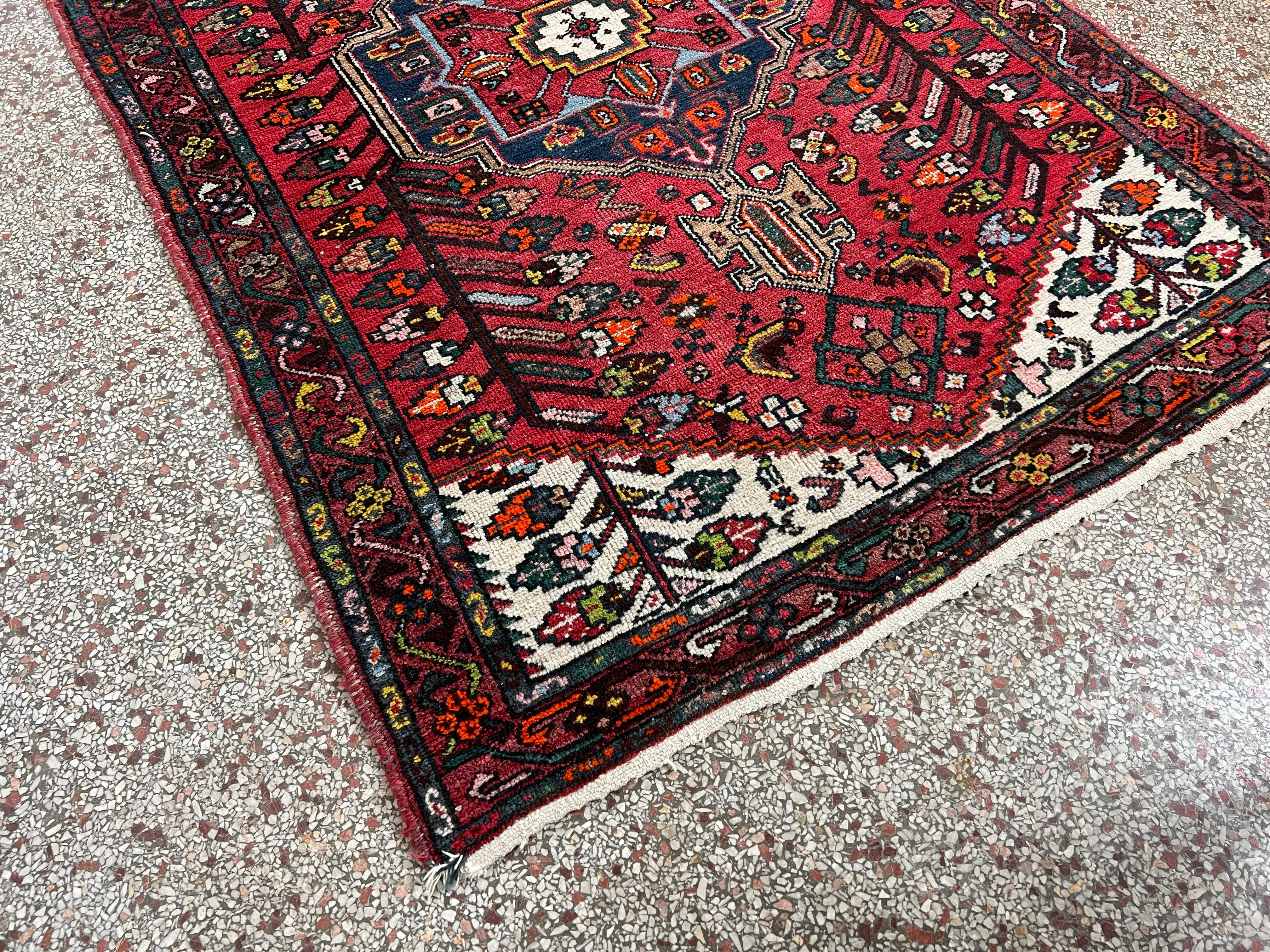 Vintage hand knotted Afghan tribal Baluchi 4'x6' wool area rug with intricate patterns in red, blues, whites and yellows. 

Origin: Middle East

Year: 1960s

Dimensions: 74