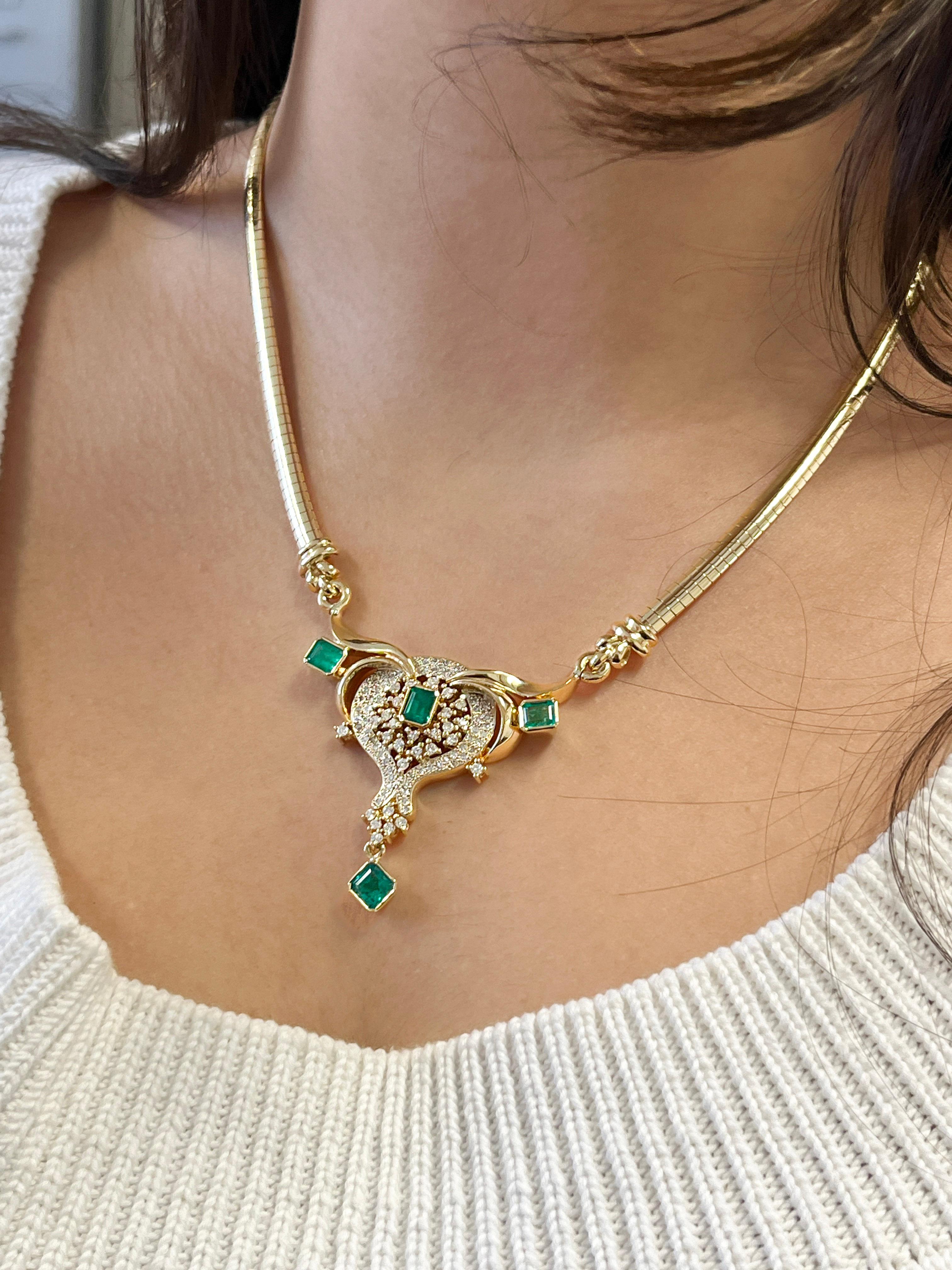 Vintage Emerald & Diamond Necklace in 14K Yellow Gold. 

This necklace features an emerald-cut emerald center stone, weighing 5 carats total. The emerald is paired with round-cut white diamond detailing, weighing 1 carat total. The necklace is