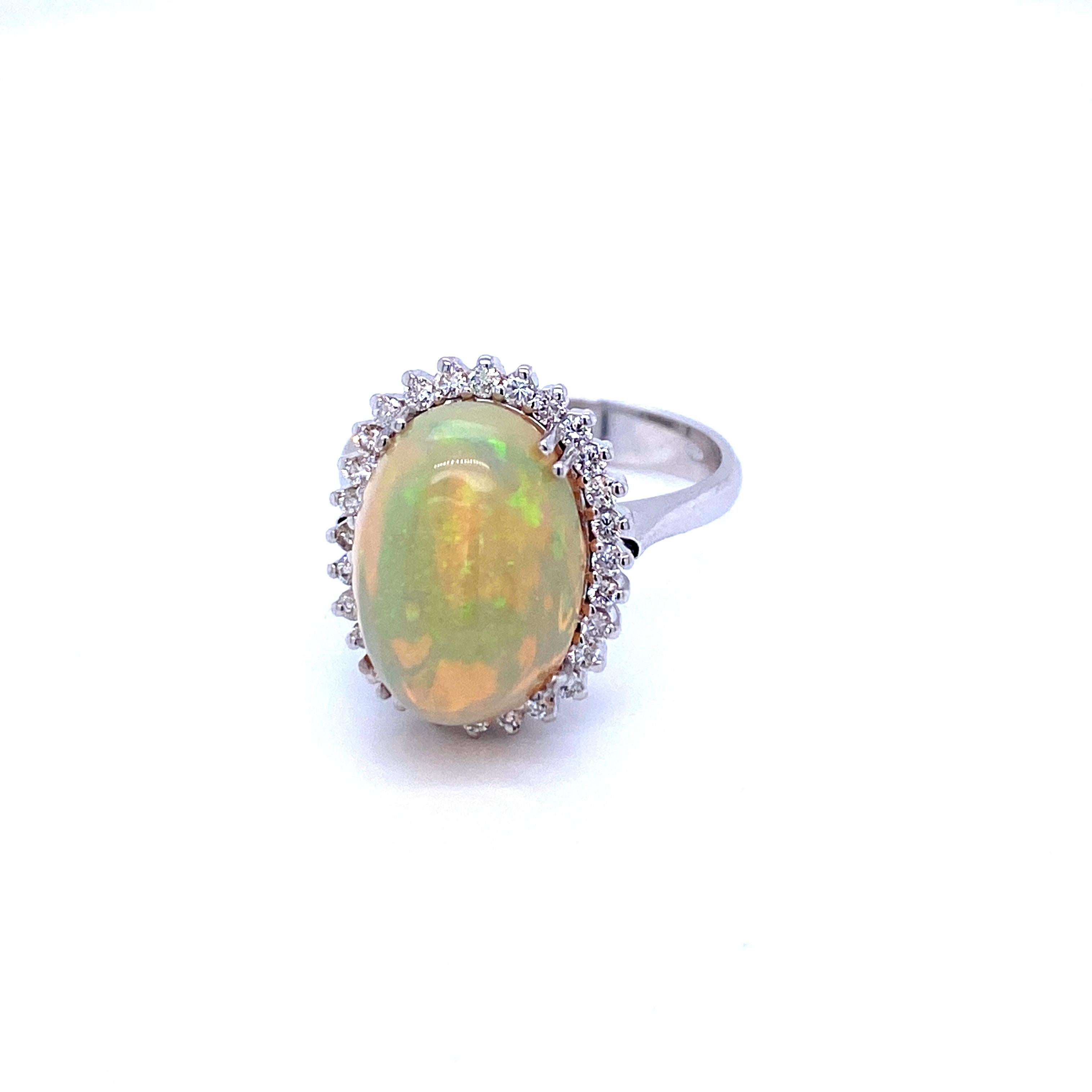 A classy contemporary piece features in the middle a wonderful Natural Ethiopian Opal weighing 5 carats surrounded by 28 Round brilliant cut Diamonds for a total weight of 0.40 carat G color Vvs1 clarity. The ring is set in a 18k white gold, origin