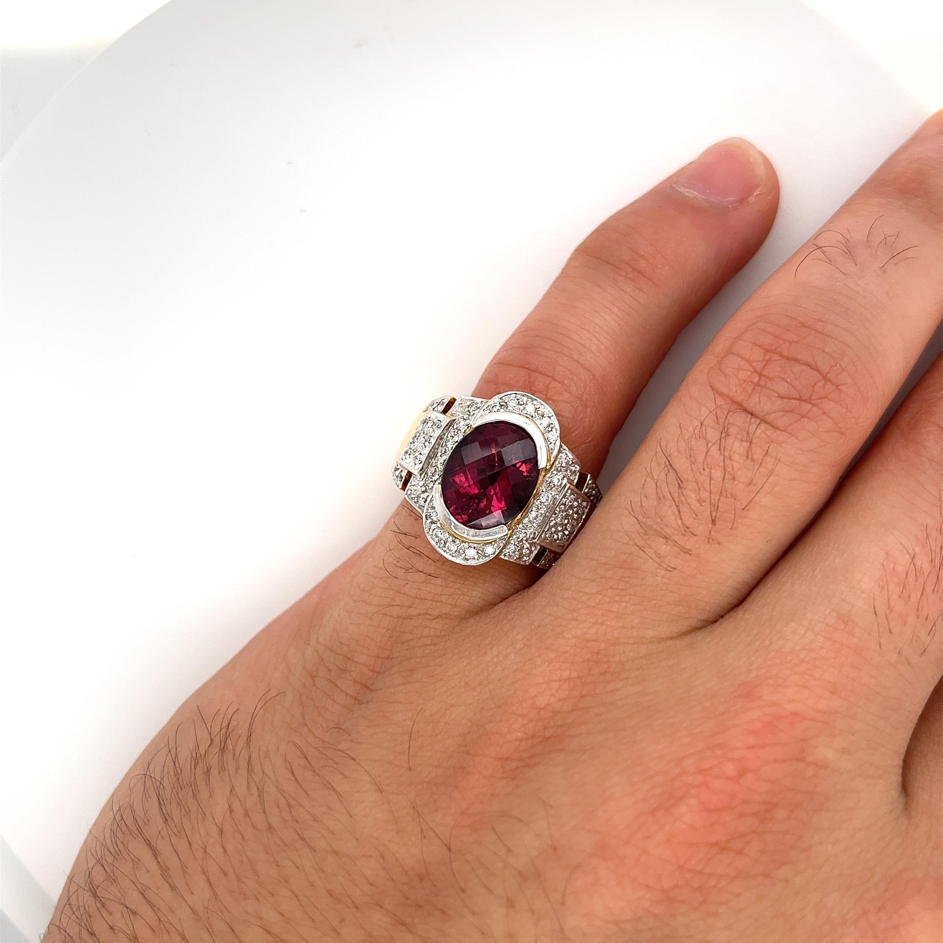 Vintage semi precious gemstone ring, featuring a pinkish red tourmaline and diamond blend of stones. The tourmaline sports a unique oval shape with a 