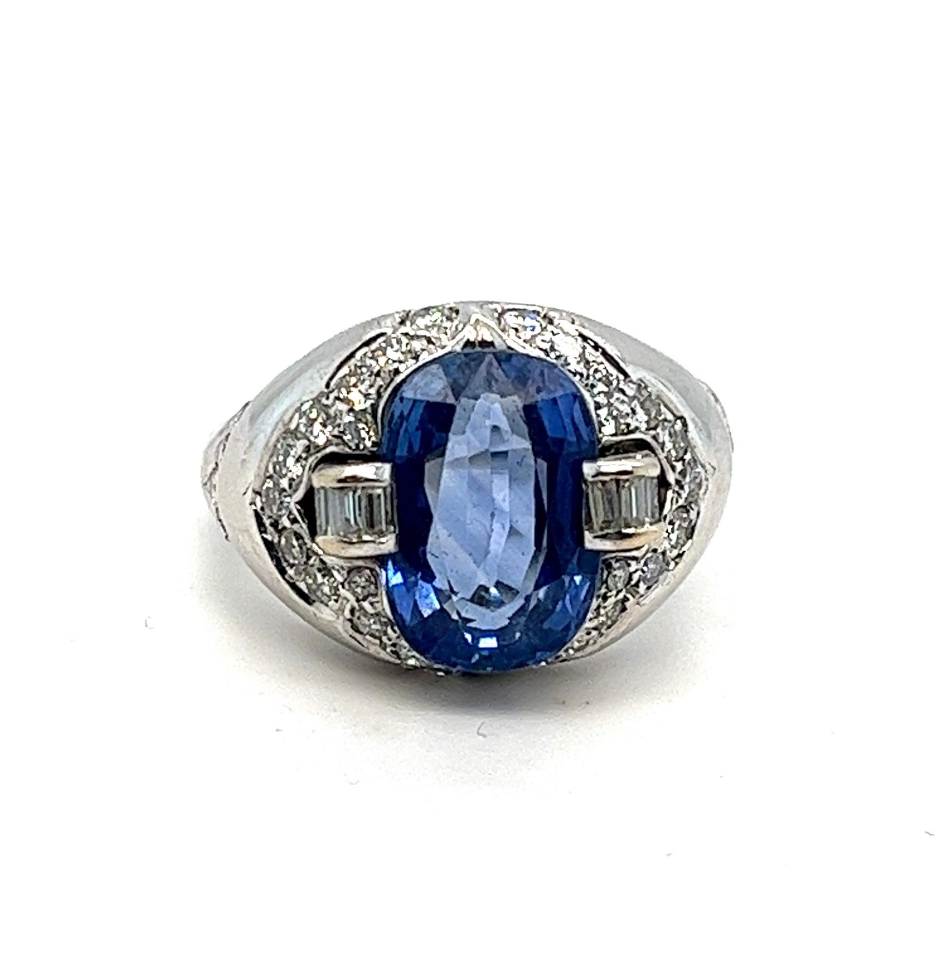 
Indulge in the allure of this captivating 18kt white gold cocktail ring, featuring a remarkable center piece heated natural blue sapphire weighing approximately 4 carats from the renowned mines of Ceylon. The mesmerizing blue hue of the sapphire is