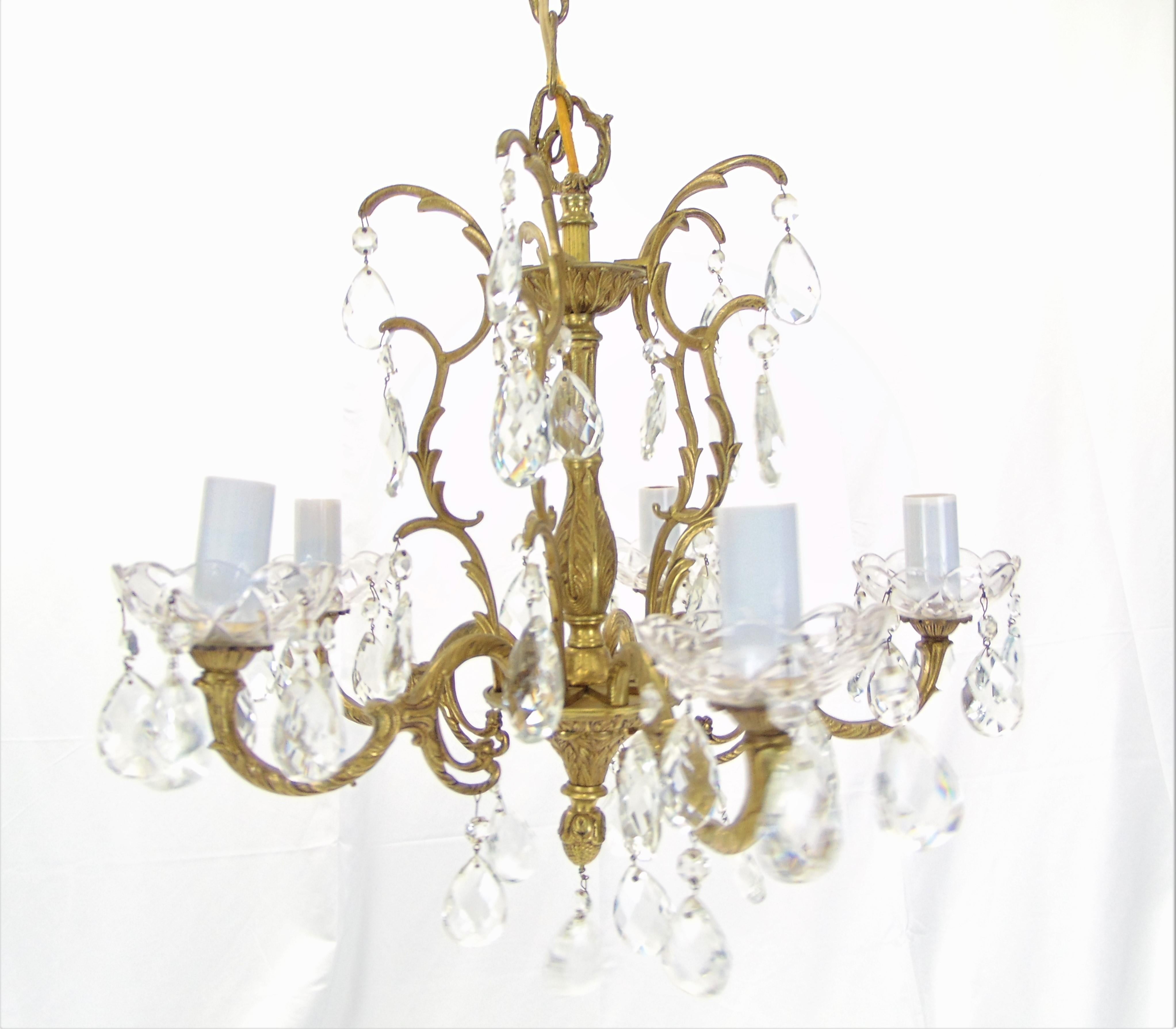 This is a beautiful vintage brass and crystal chandelier made in Spain. It holds 5 lights. This chandelier holds a larger sized light bulb than most chandeliers.
Measures: 21'' D x 21'' W x 17.5'' H.