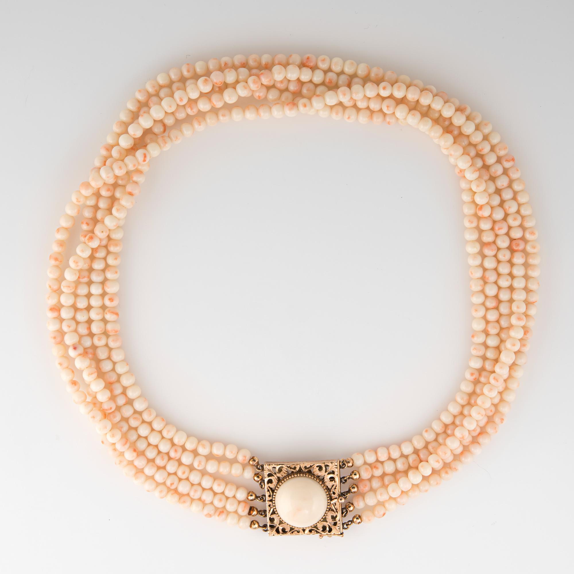 Finely detailed vintage angel skin coral necklace finished with a 14 karat yellow gold clasp (circa 1950s to 1960s). 

5 strands of angel skin coral beads are uniform in size measuring 4.5mm each. The clasp is set with a 16.2mm piece of angel skin