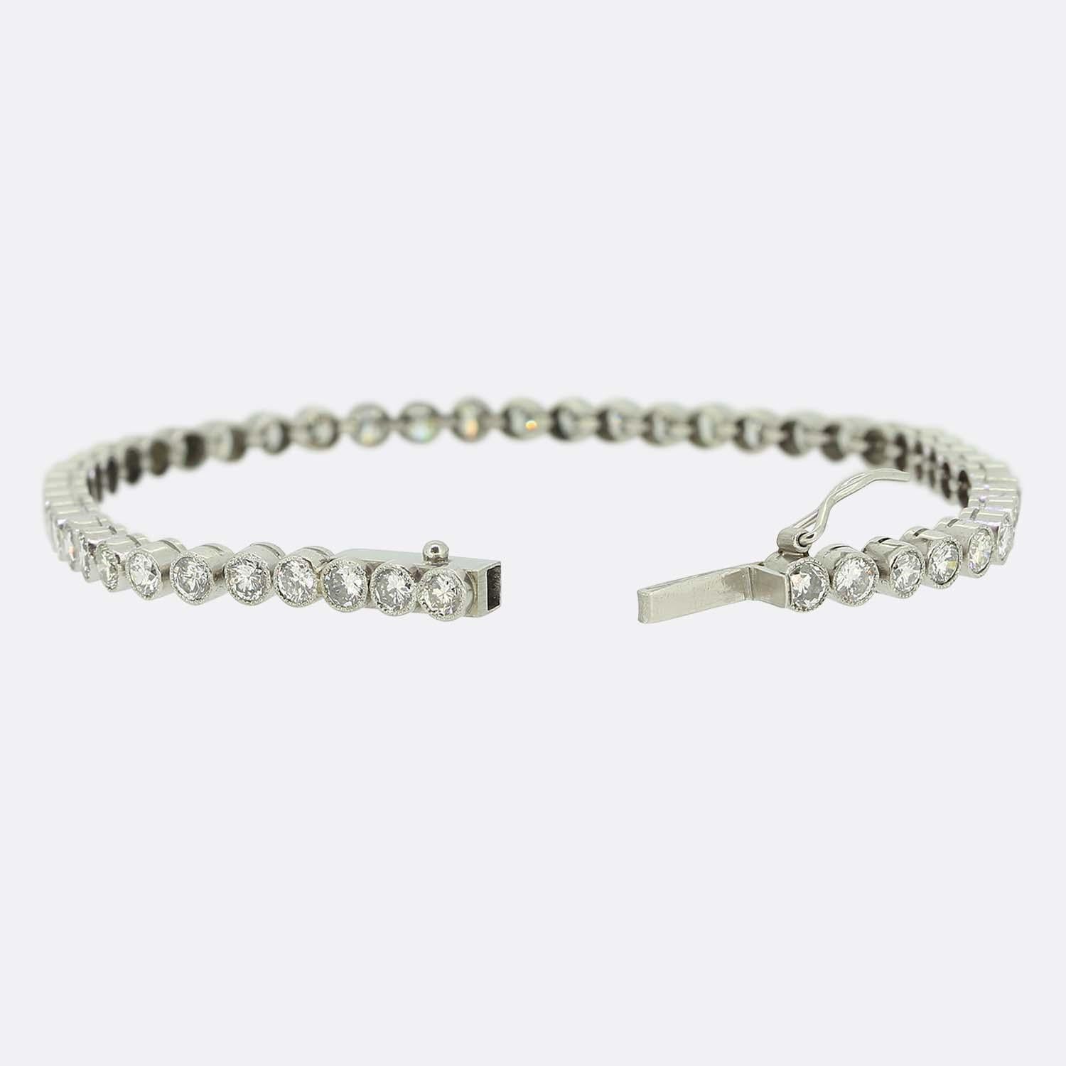 Here we have a delightful diamond line bracelet. This vintage piece has been crafted from platinum and showcases 49 round brilliant cut diamonds in a single line formation. Each bright white stone is well matched to its counterpart whilst being
