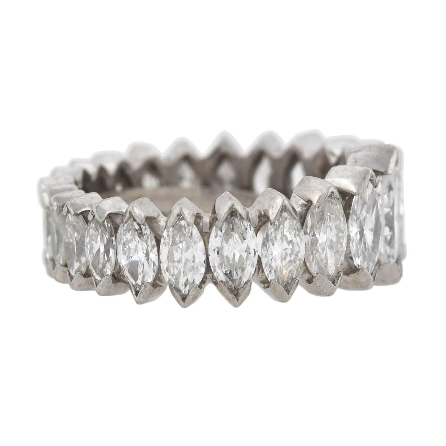 A stunning Vintage diamond eternity band from the 1960s era! Crafted in platinum, this unique ring features a mesmerizing row of Marquise Cut diamonds that subtly graduate in size towards the back. With 23 in total, each stone is held in a