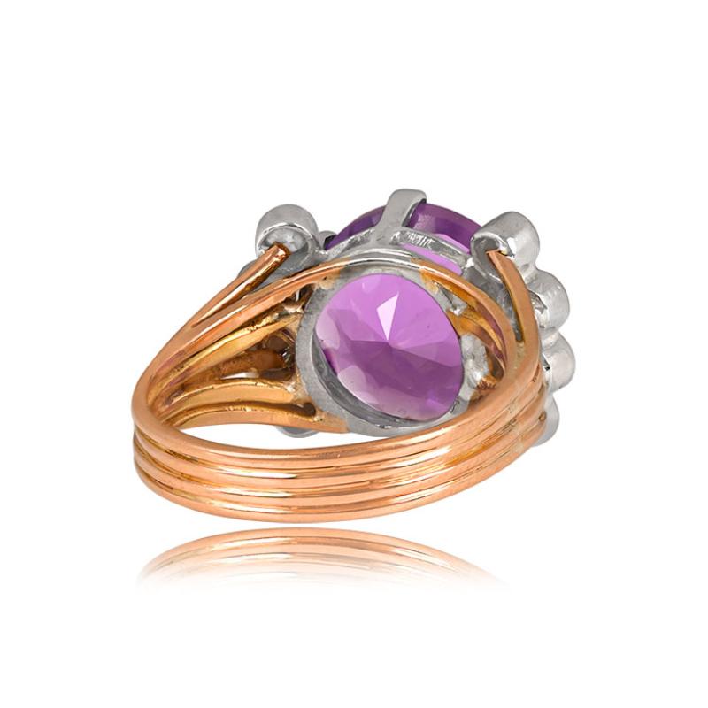 A vintage 18k yellow gold ring showcasing a 5.00-carat round natural amethyst center stone held in prongs. Eight round diamonds, each around 0.07 carats, provide elegant accents. The ring's four-wire band design adds a unique touch. Hand-crafted