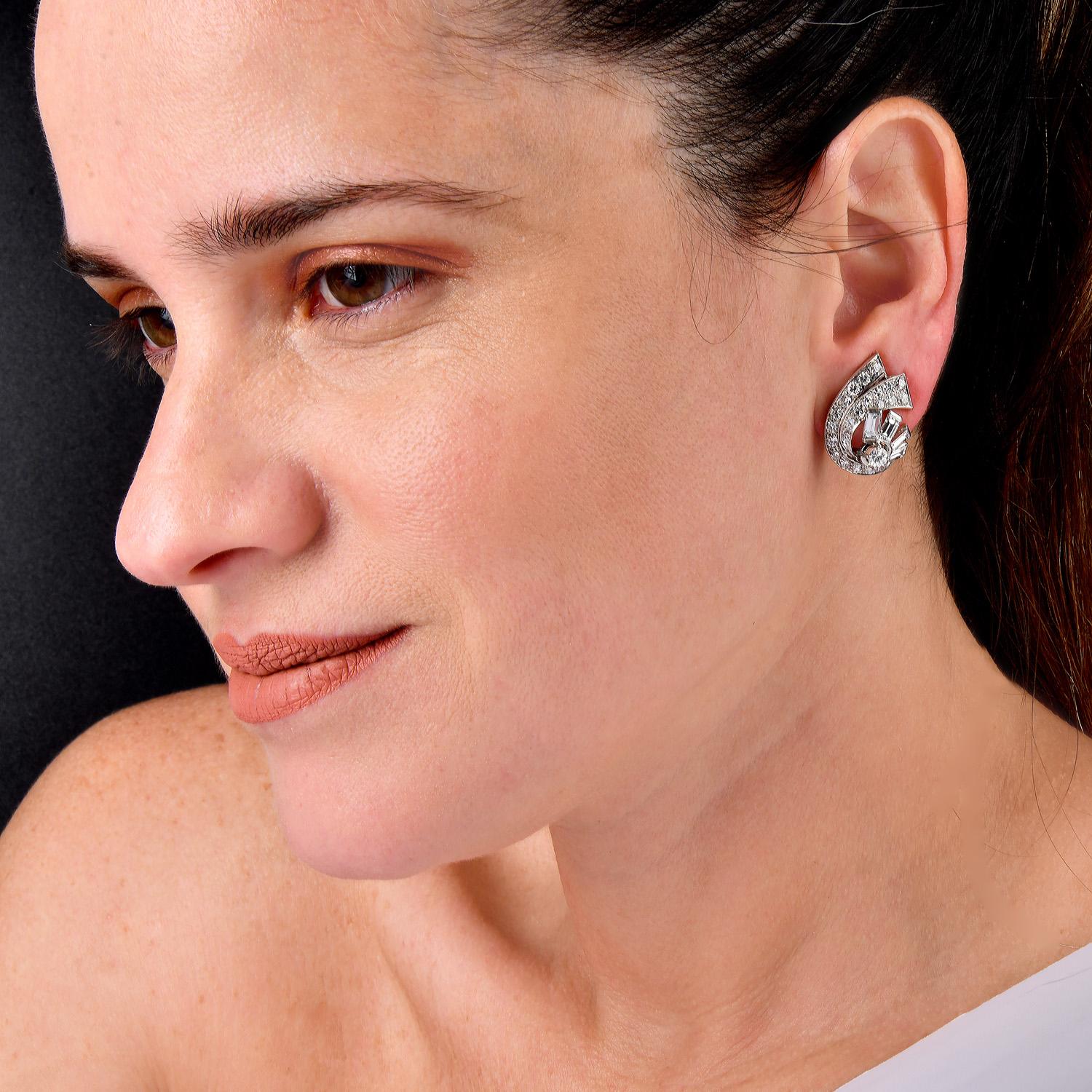 Classic Vintage Diamond Platinum Statement Stud Earrings. These stunning earrings are crafted in luxurious platinum and feature a sophisticated spray design.

They Are adorned with 58 natural round and baguette diamonds, totaling approximately 5.00