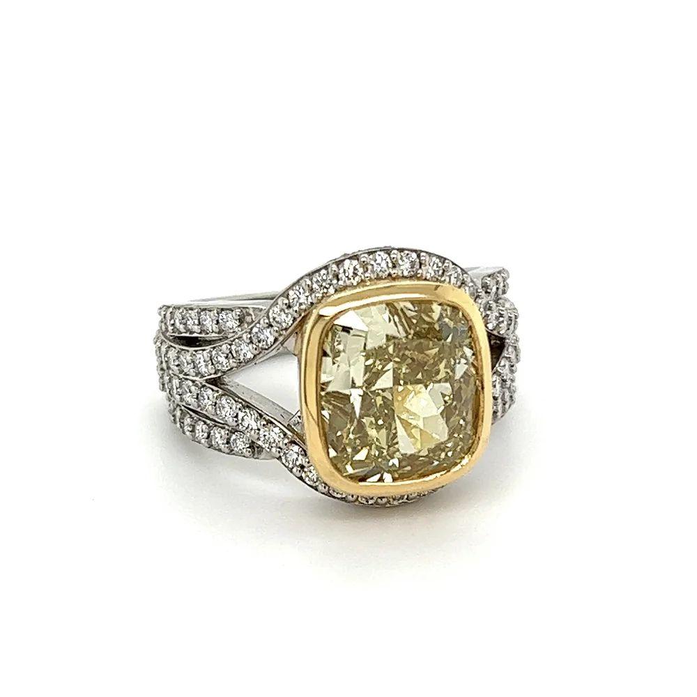 Simply Beautiful! Finely detailed GIA Fancy Yellow Cushion Diamond and White Diamond Vintage Platinum Gold Cocktail Ring. Centering a securely nestled Hand set 5.06 Carat Cushion Fancy Yellow Brownish Greenish Diamond surrounded by White Diamonds,
