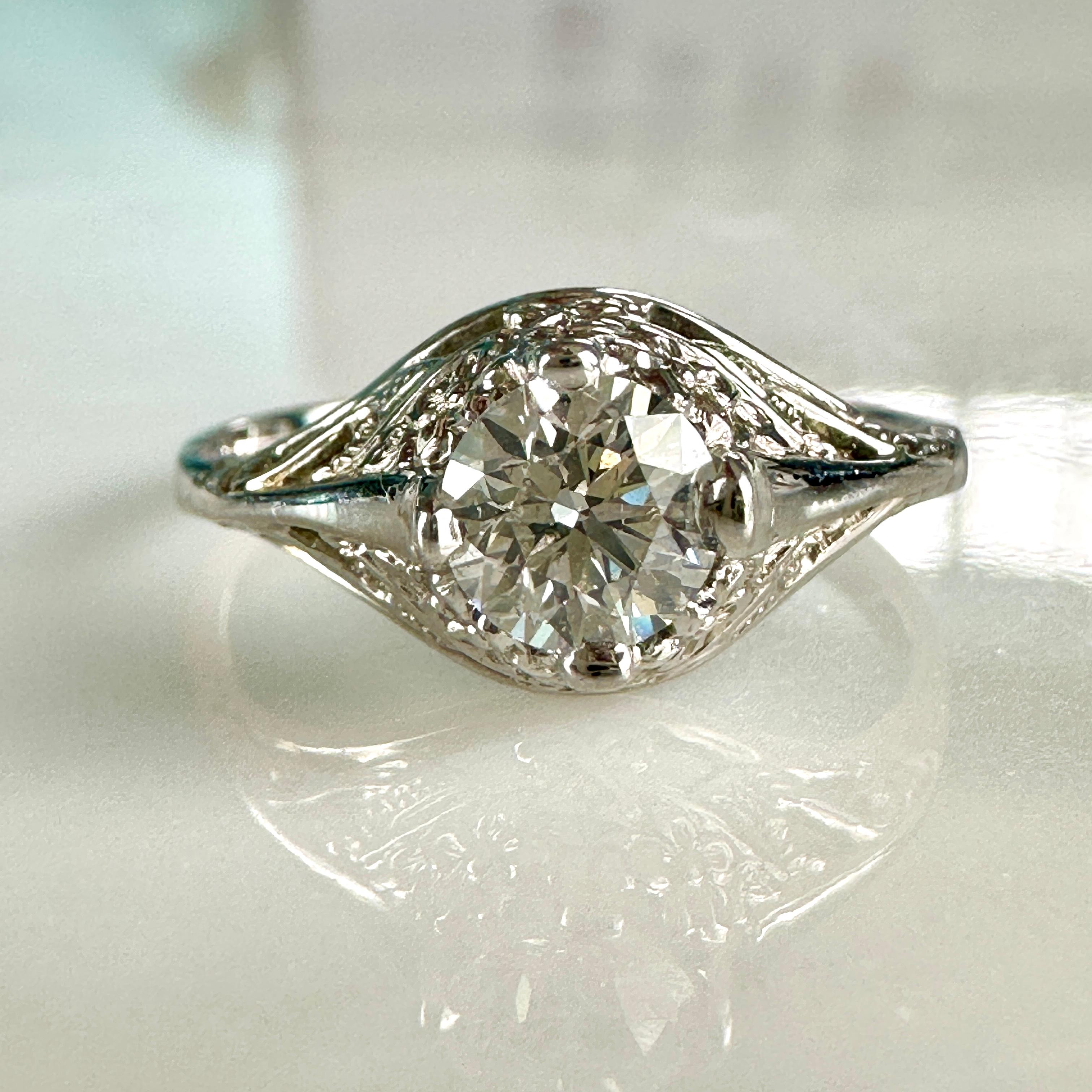 Details:
Pretty 14K white gold filigree  1/2 carat diamond ring from the 1920's! The filigree has beautiful sweet flowers in the 14K gold. The height of the ring sits up 5.6mm, and the diamond measures 5.25mm round. This ring has an appraisal.