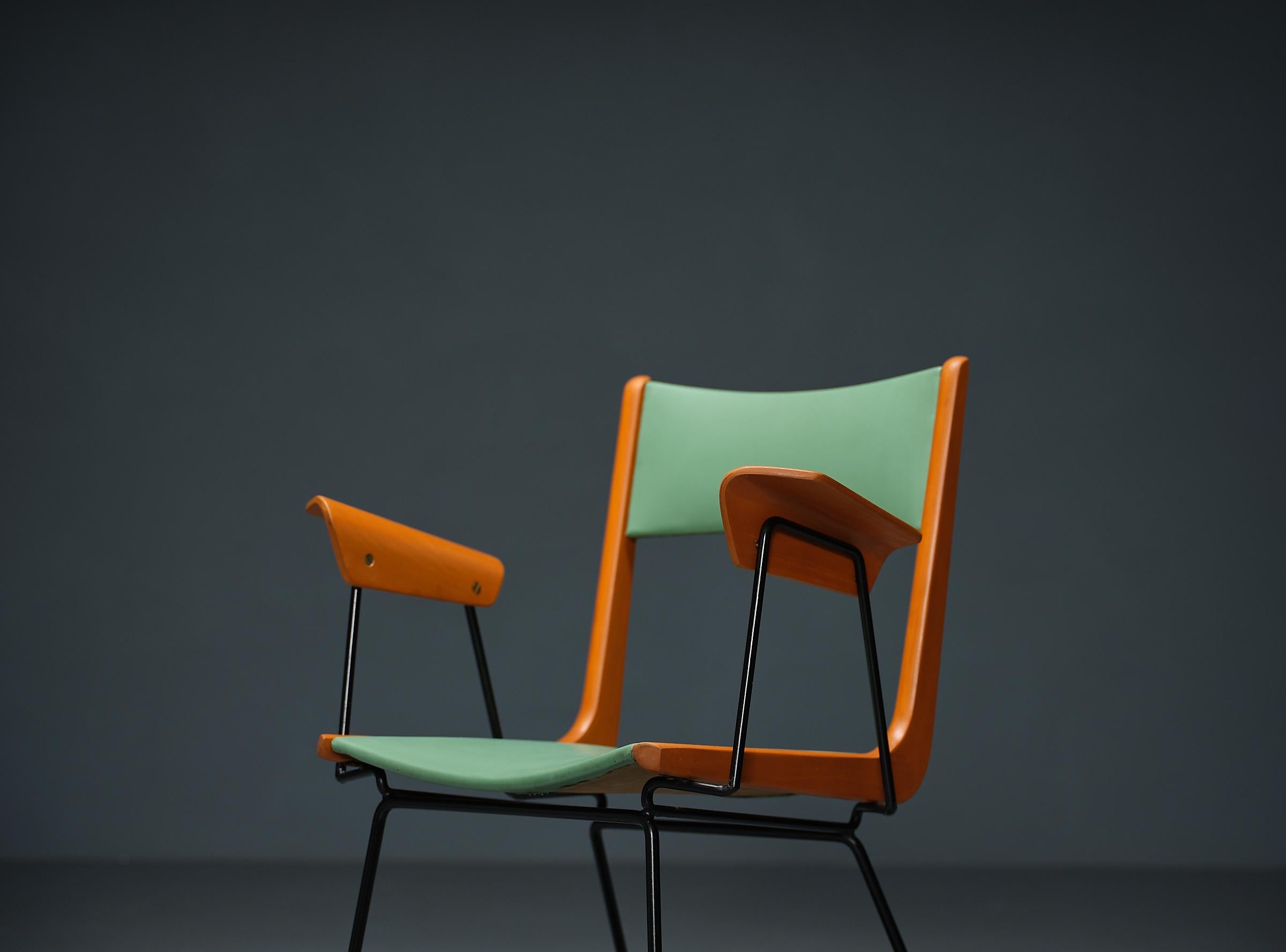 Italian-designed '' Boomerang '' Desk Chair by Carlo Ratti. This modern and playful chair exudes joy with its colorful and cheerful Skai upholstery in original green, perfectly complementing its restored wooden frame crafted from beechwood and black