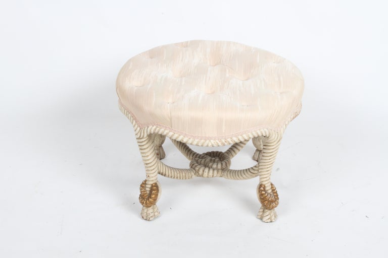 Vintage Napoléon IIII style or Hollywood Regency round tufted upholstered ottoman. This Italian made cream painted & gold gilt, faux wood rope tassel ottoman, stool or bench, has wear to paint, as seen in photos. Upholstery should be updated, stains