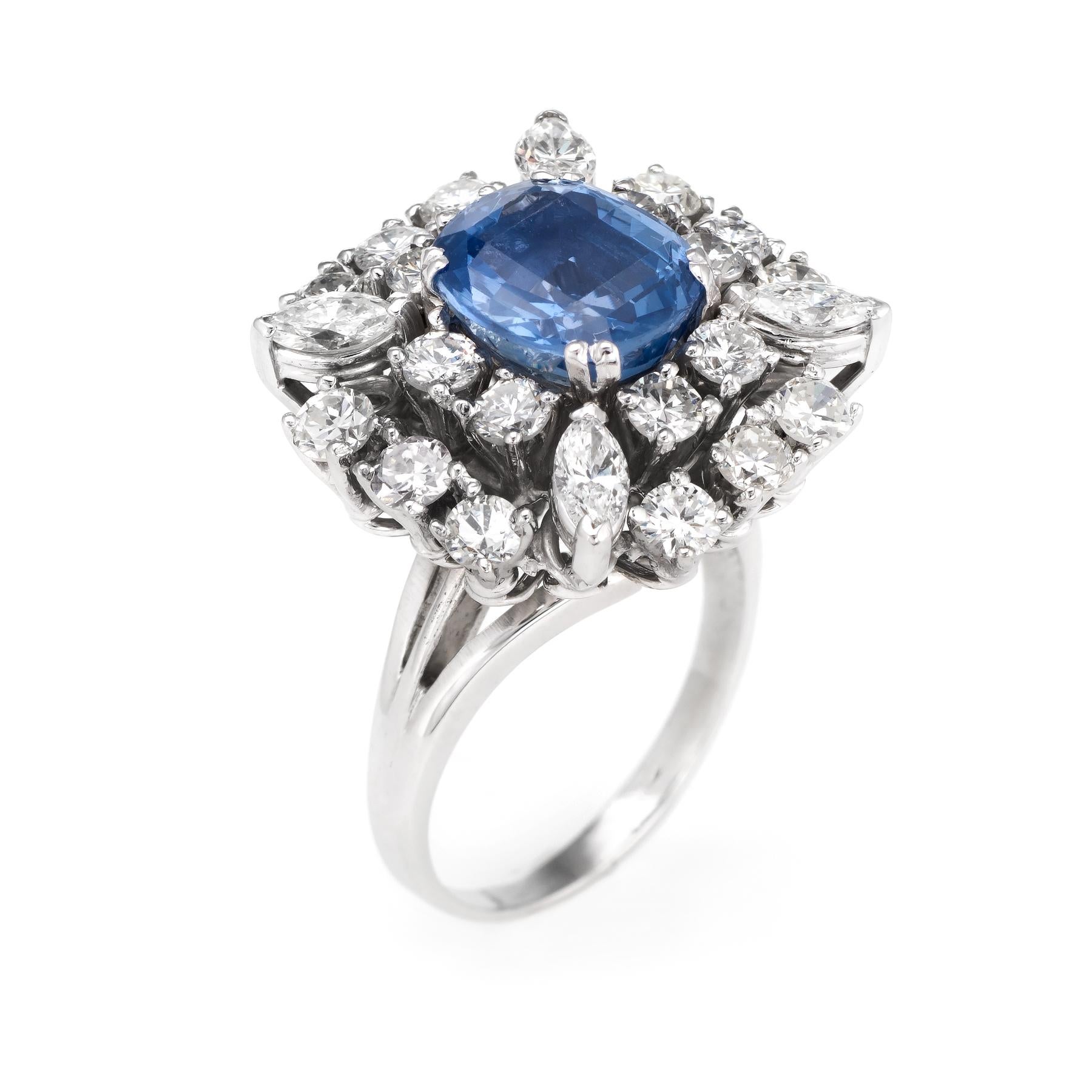 Circa 1950, a large statement cocktail of square cluster design is crafted in 18 karat white gold. 

One oval shaped mixed cut Natural Sapphire weighs approx. 4.10 carats (9.38 x 8.85 x 5.60), medium blue color, nearly flawless, good cut. Color and