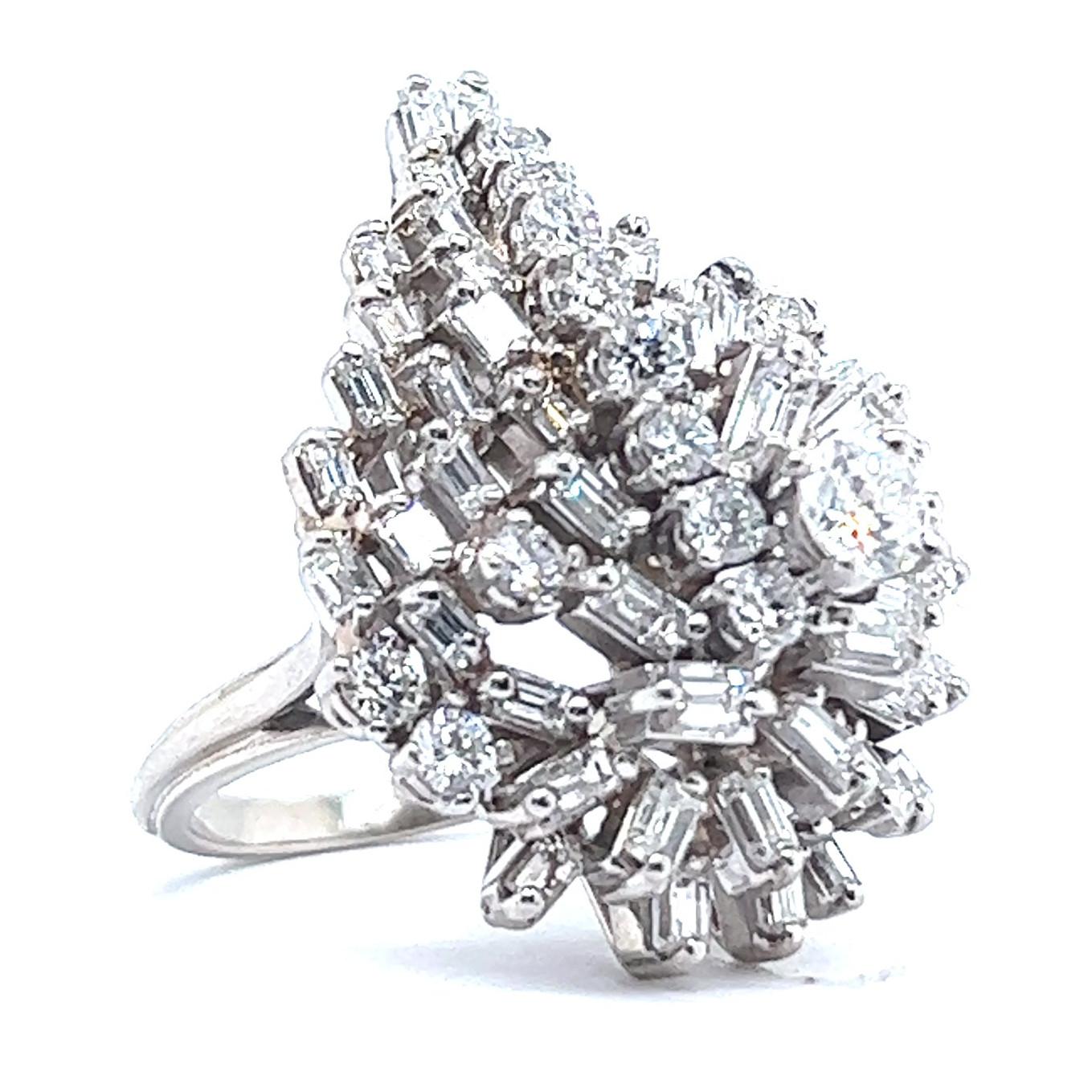 One Vintage 5.10 Carats Diamonds 18 Karat White Gold Cluster Cocktail Ring. Featuring 13 round brilliant cut diamonds with a total weight of approximately 1.60 carats, graded F color, VS clarity. Accented by 45 baguette cut diamonds with a total