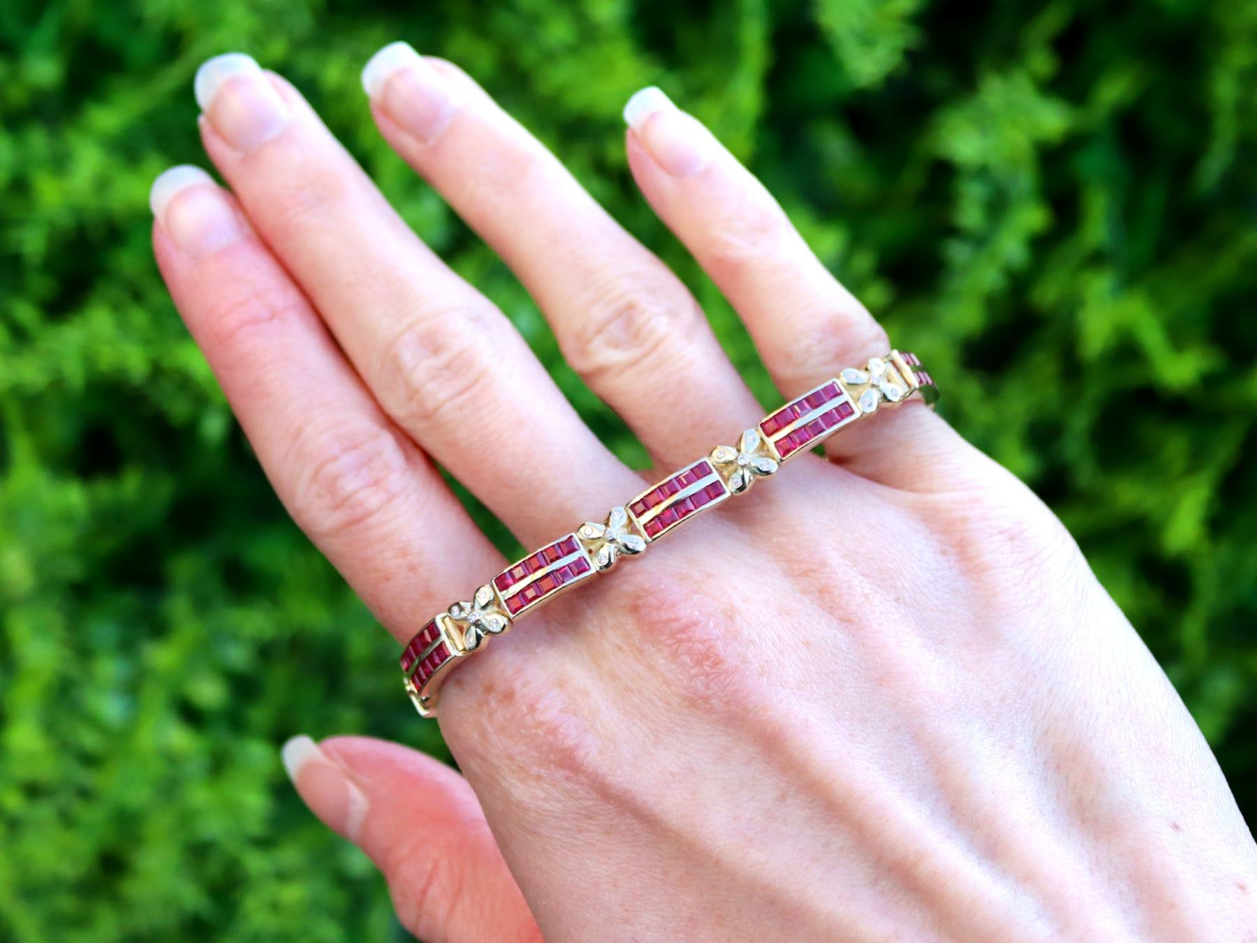 A stunning, fine and impressive vintage 5.50 carat ruby, 0.45 carat diamond and 14 karat yellow gold bracelet; part of our diverse vintage ruby jewelry and estate jewelry collections.

This stunning, fine and impressive vintage bracelet has been