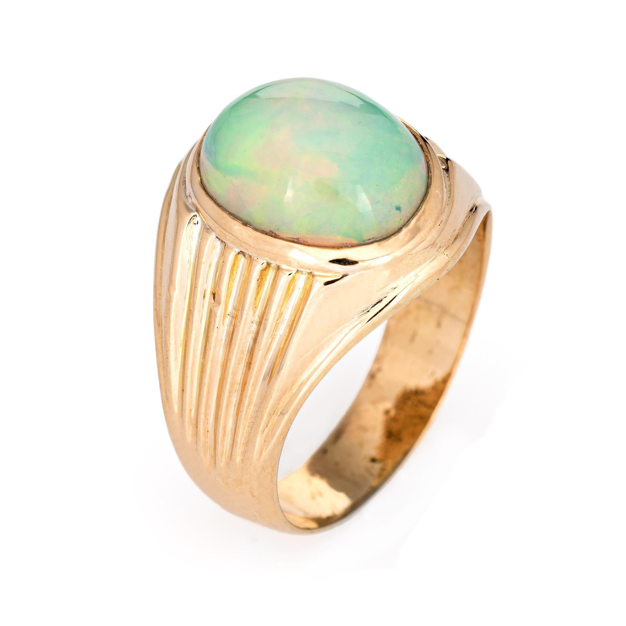 Stylish vintage 5.50ct opal ring crafted in 18 karat yellow gold (circa 1960s to 1970s).

The cabochon cut opal measures 12.5mm x 10mm (estimated at 5.50 carats). The opal is in excellent condition and free of cracks or chips. 

The natural opal
