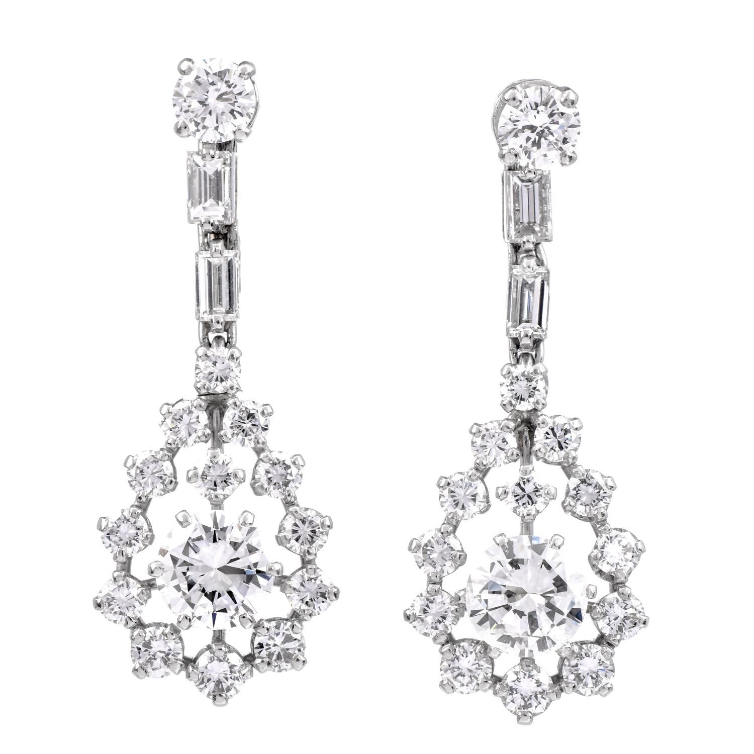 Presenting a beautiful pair of Platinum Diamond earrings. Teardrop dangling earrings adorned with 34 natural Brilliant round and Baguette diamonds. The two center diamonds are 2.10 carats in total. surrounding diamonds ranging from 0.09 carat to