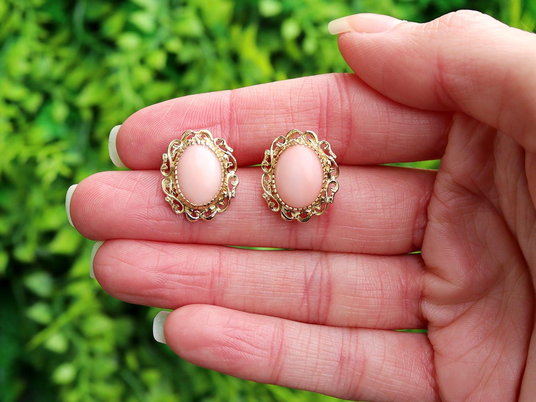 An impressive pair of vintage 1960s 5.75Ct pink coral and 18 karat yellow gold stud earrings; part of our diverse vintage jewelry and estate jewelry collections.

These fine and impressive vintage cabochon cut earrings have been crafted in 18k
