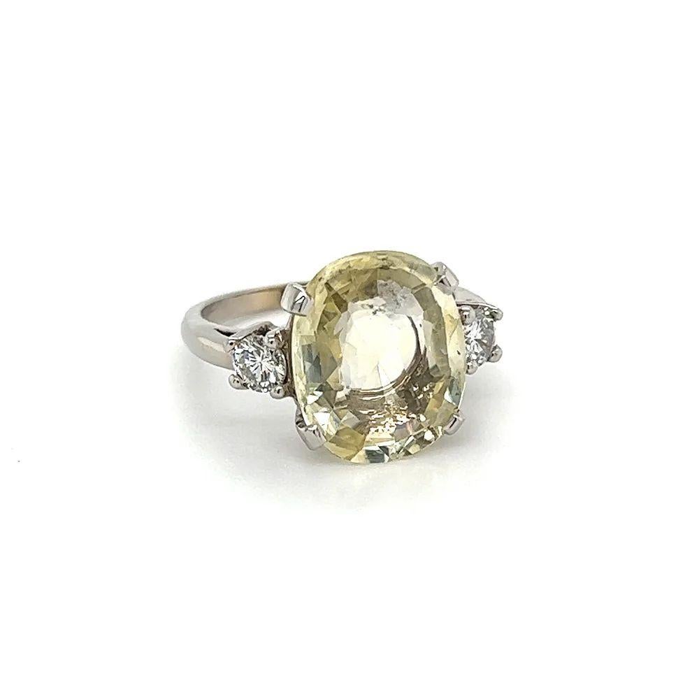 Simply Beautiful! Finely detailed GIA Yellow Sapphire and Diamond Vintage Gold Cocktail Ring. Centering a securely nestled Hand set 5.94 Carat Oval NO HEAT Yellow Sapphire accented by RBC Diamonds, weighing approx. 0.33tcw. Hand crafted White Gold