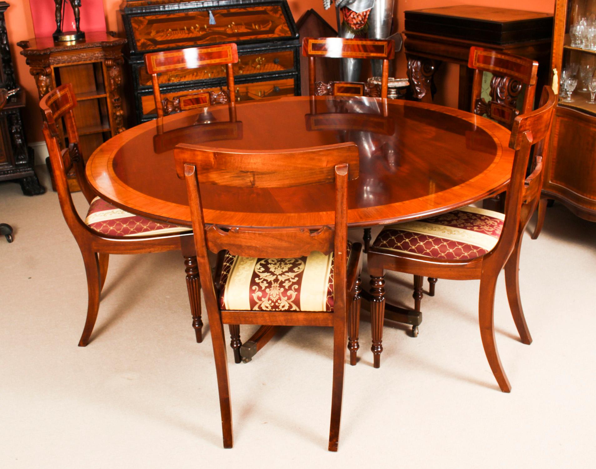 This is a beautiful Regency Revival diniung suite comprising a flame mahogany circular dining table dating from Circa 1980 and a set of six flame mahogany dining chairs.

The fabulous 5ft 3 inch diameter flame mahogany table was made by the Master