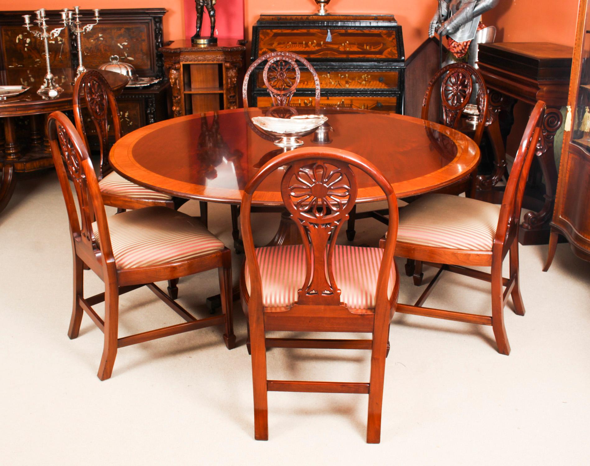 This is a beautiful Regency Revival diniung suite comprising a flame mahogany circular dining table dating from Circa 1980 and a set of six Hepplewhite Revival dining chairs.

The fabulous 5ft 3 inch diameter flame mahogany table was made by the