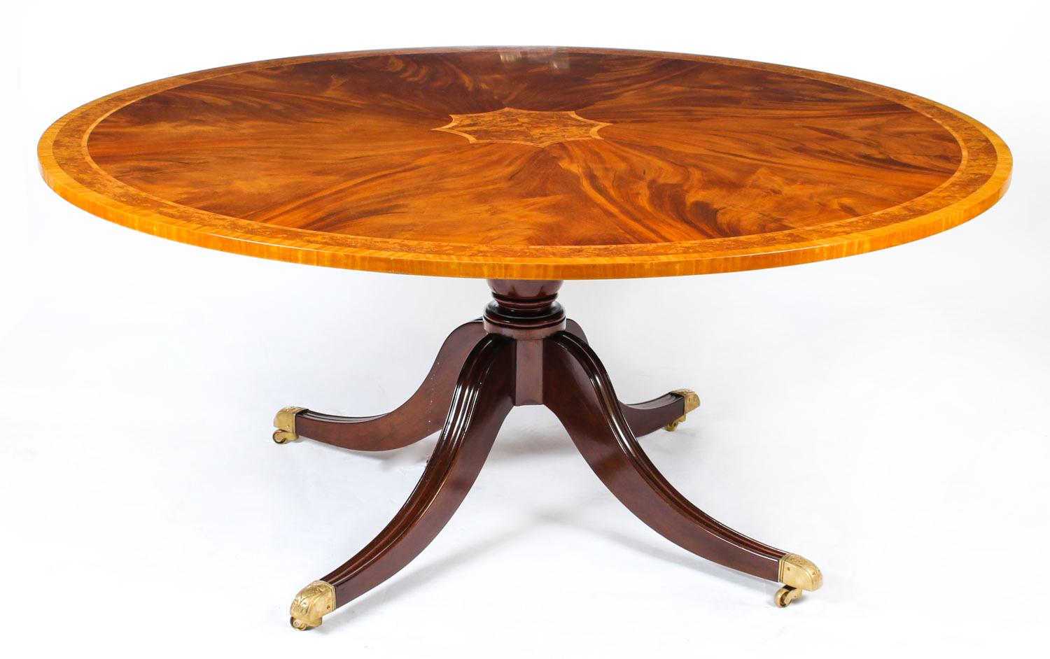 This is a magnificent dining suite comprising an English flame mahogany Regency Revival dining table dating from the mid-20th century and a matching set of eight dining chairs. Measures: 5ft 6