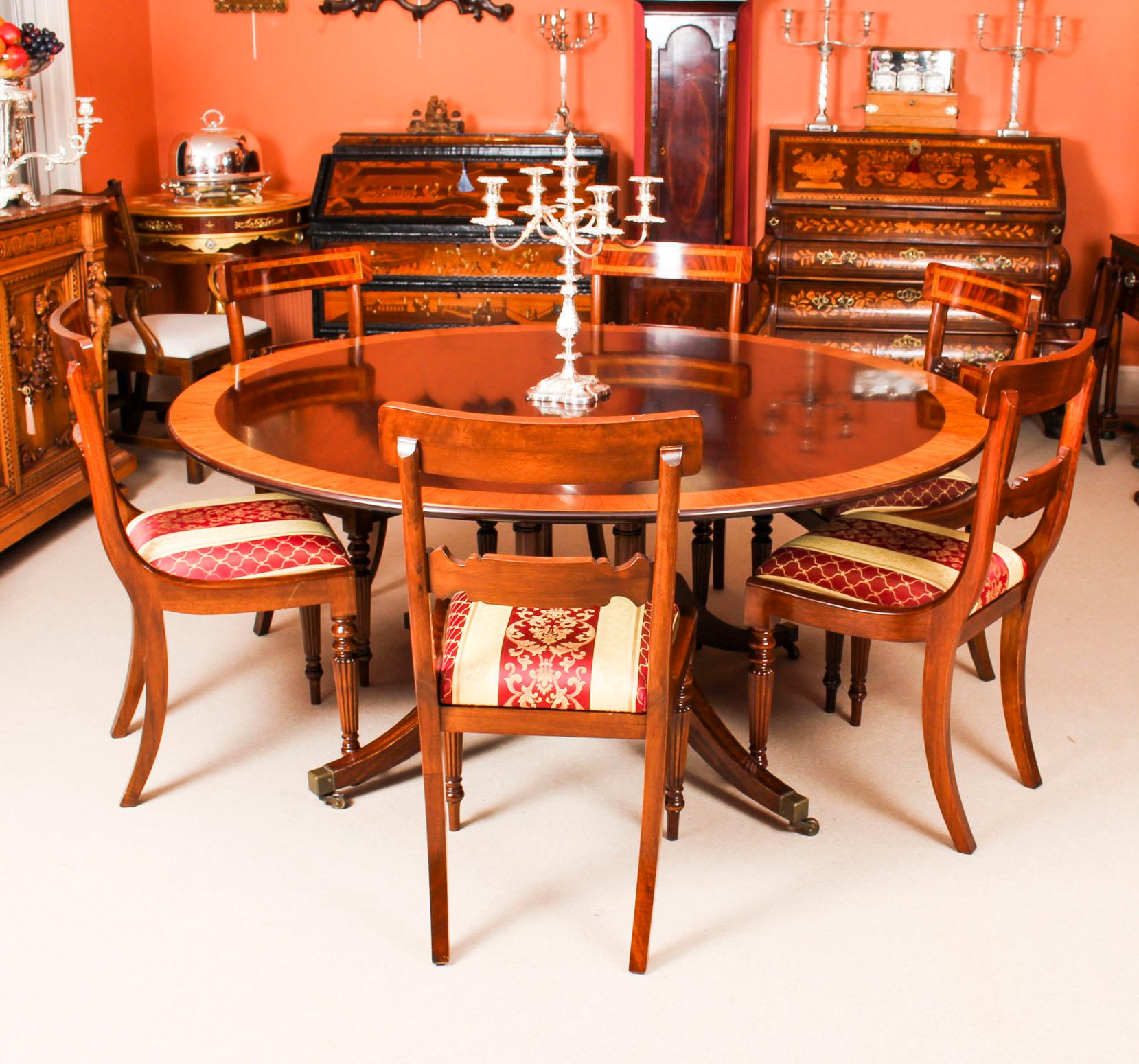 This beautiful dining set comprising a Regency style flame mahogany dining table made by the Master Cabinet maker Master Cabinet makers Millwood, of Wittersham Kent, and bears their brass label on the underside, circa 1970 in date, with a set of six