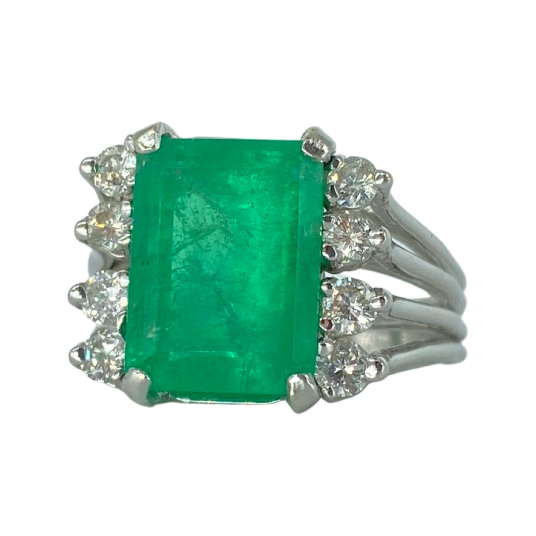 Vintage 6 Carat Emerald and Diamonds Cocktail Ring. Very elegant and bold standout ring with a large center emerald gemstone weighing approx 5 carat and surrounded by the sides diamonds natural weight approx 1.00 carat for a combined total weight of