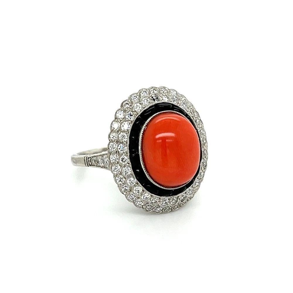 Simply Beautiful! Finely detailed Coral, Onyx and Diamond Platinum Cocktail Ring, Centering a securely Hand set 6 Carat Oval Cabochon Coral. Surrounded by 66 OEC Diamonds, approx. 1.11tcw and 15 custom cut Onyx, approx. 1ttcw. Hand crafted in