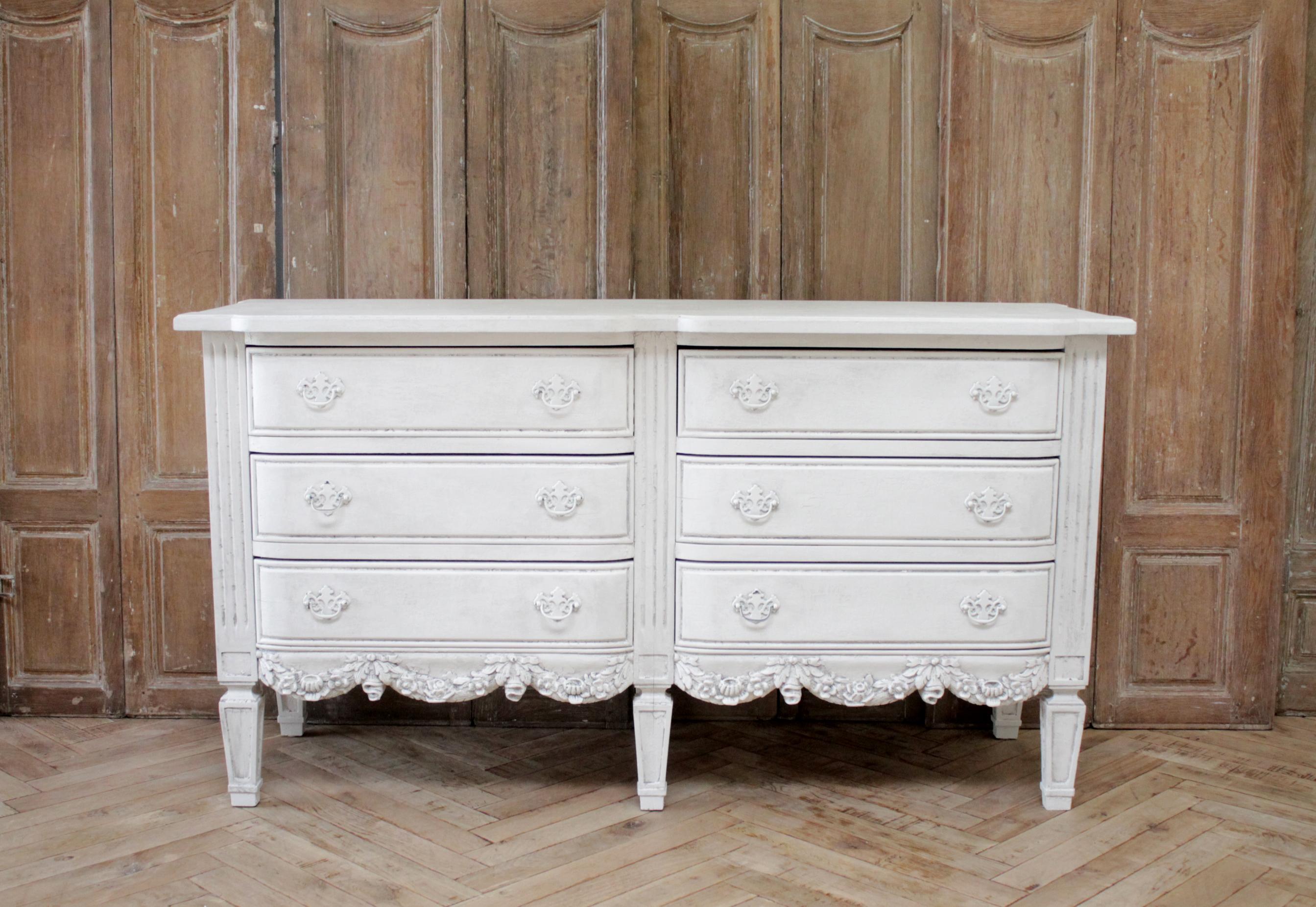Vintage 6-drawer dresser with rose swag carvings
Painted in an off white finish, with an antique patina. The overall piece has a vintage finish (see photos) the flat surfaces have a cracklure appearance. 
Measures: 62.5