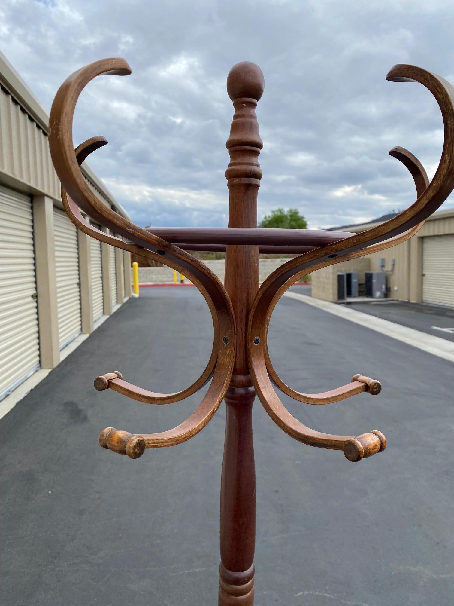 Gorgeous coatrack or coat rack, hall tree. It is 6 feet tall (72 inches) and has a revolving or spinning top. The top portion has 6 upper and 6 lower hangers. The bottom has three legs with a ring that is used for storing umbrellas. Both the upper