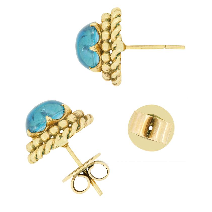 A pair of enchanting blue tourmalines - also known as Indicolite - are beautifully framed in twisted gold rope like settings in this pair of Vintage earrings. The tourmalines are cabochon cut stones of approximately 3 carats in each. Set in 9 carat